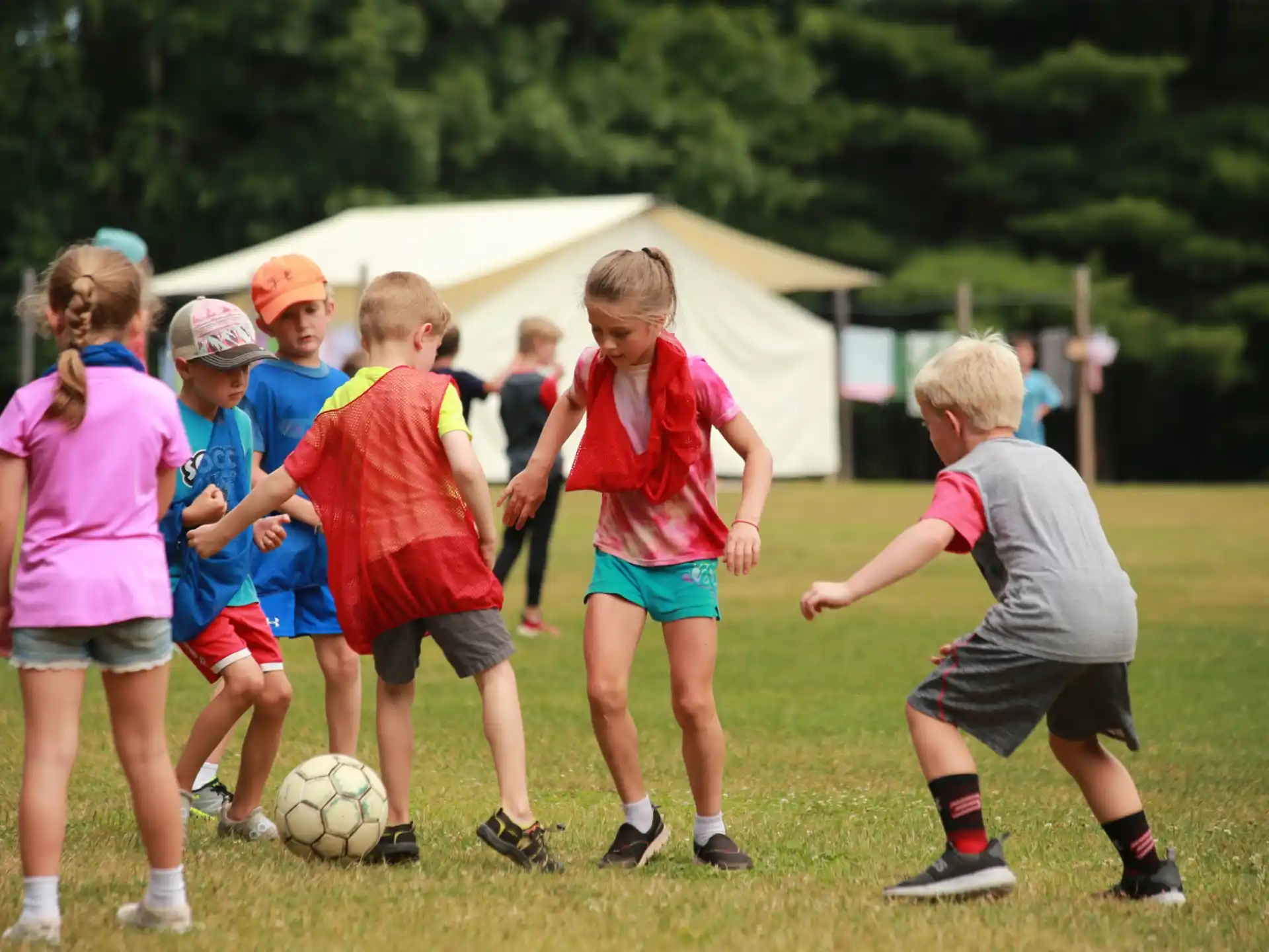 kids playing football in the grass