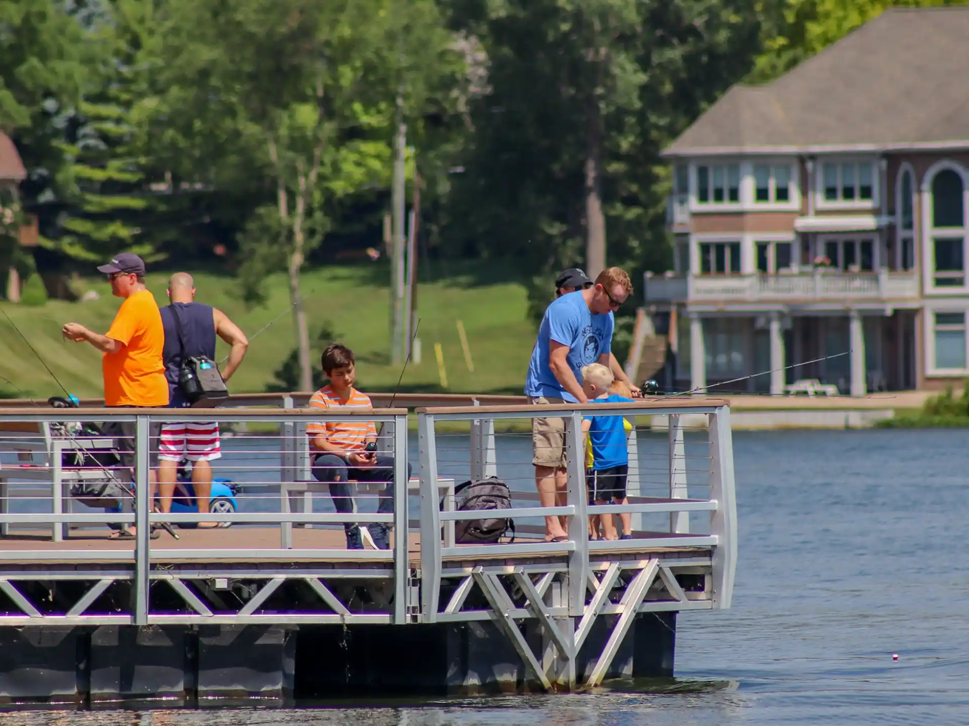 a group of people standing on a dock over water