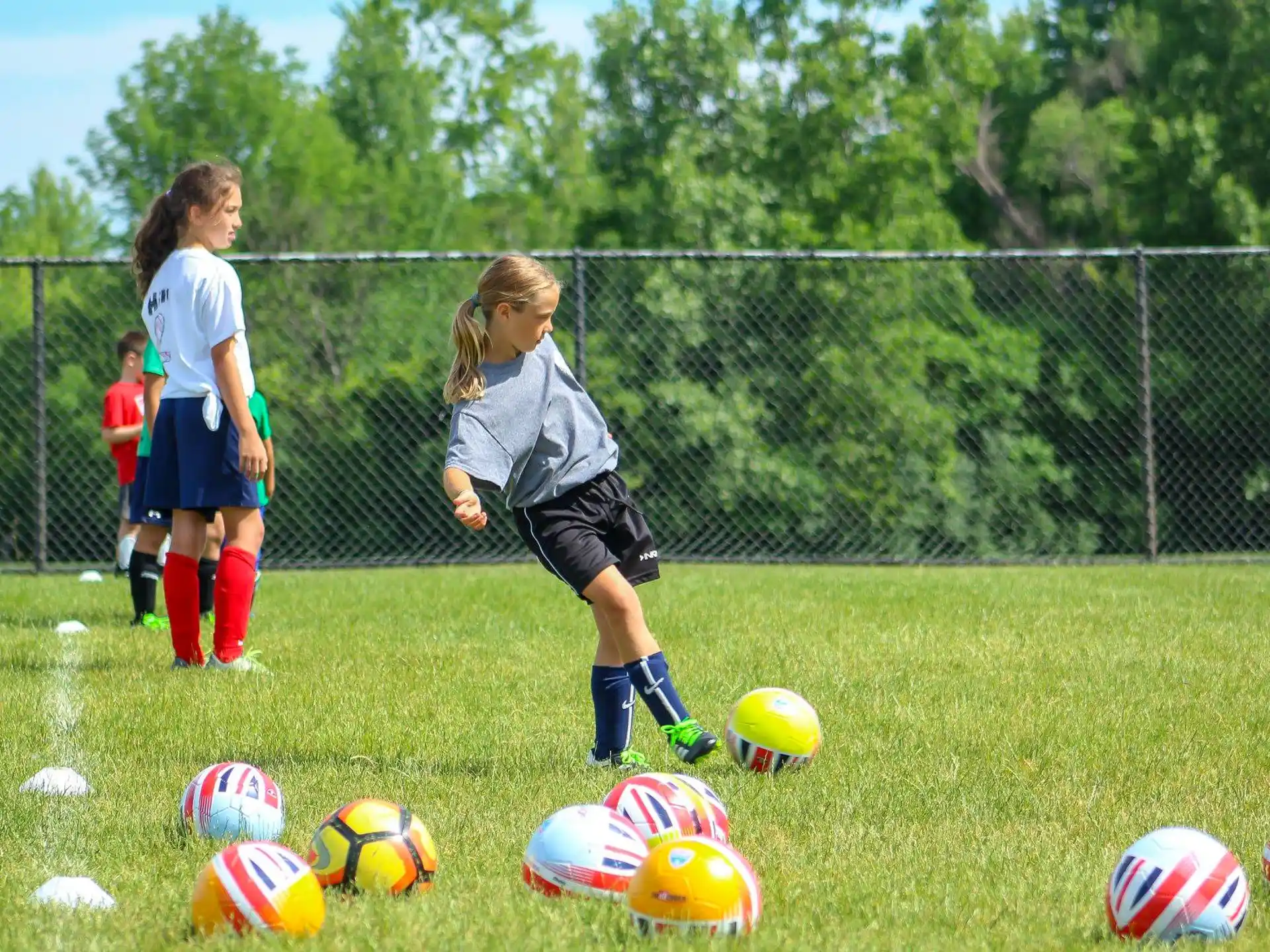 girls playing football on a field