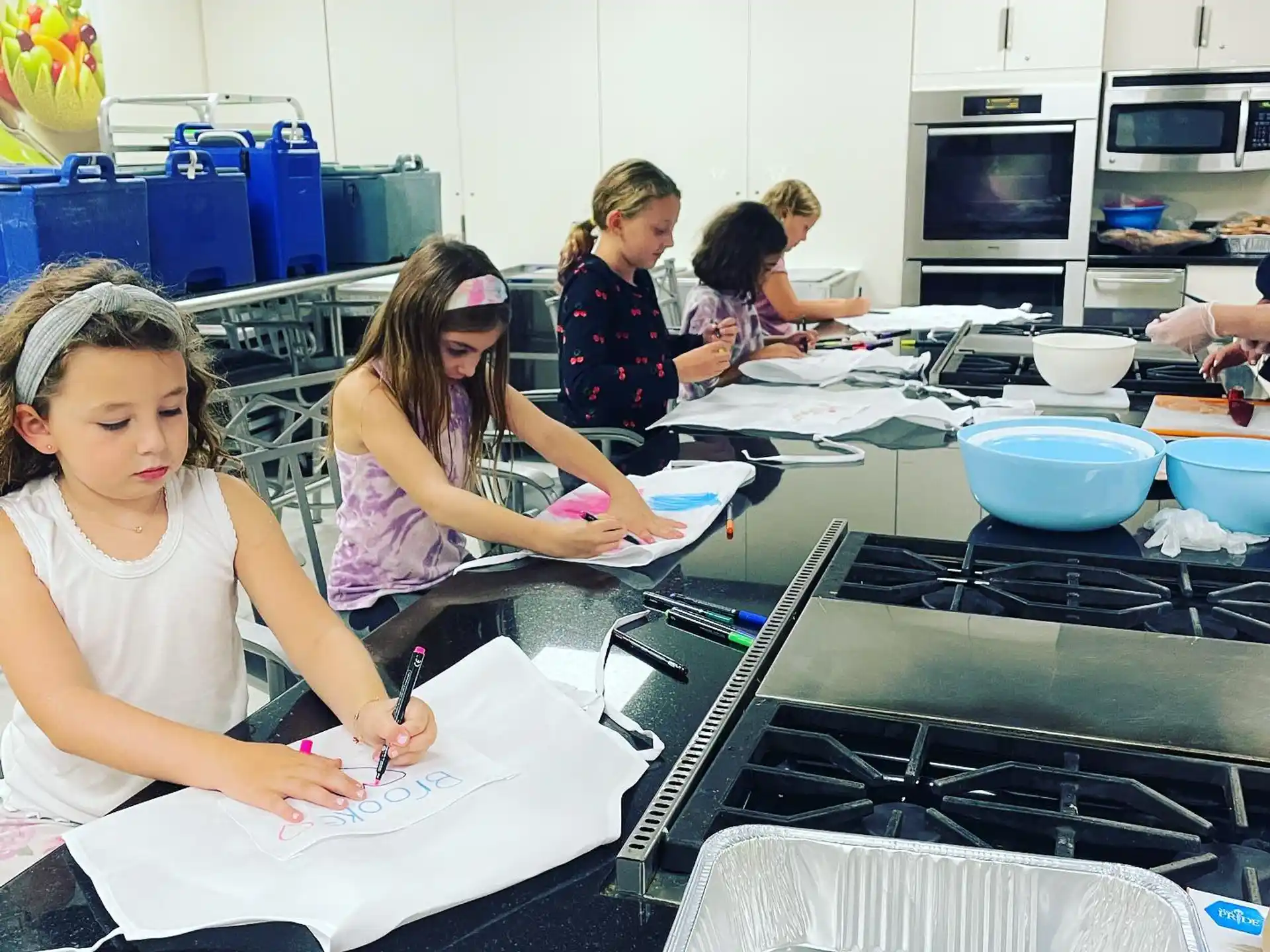 a group of girls in a kitchen
