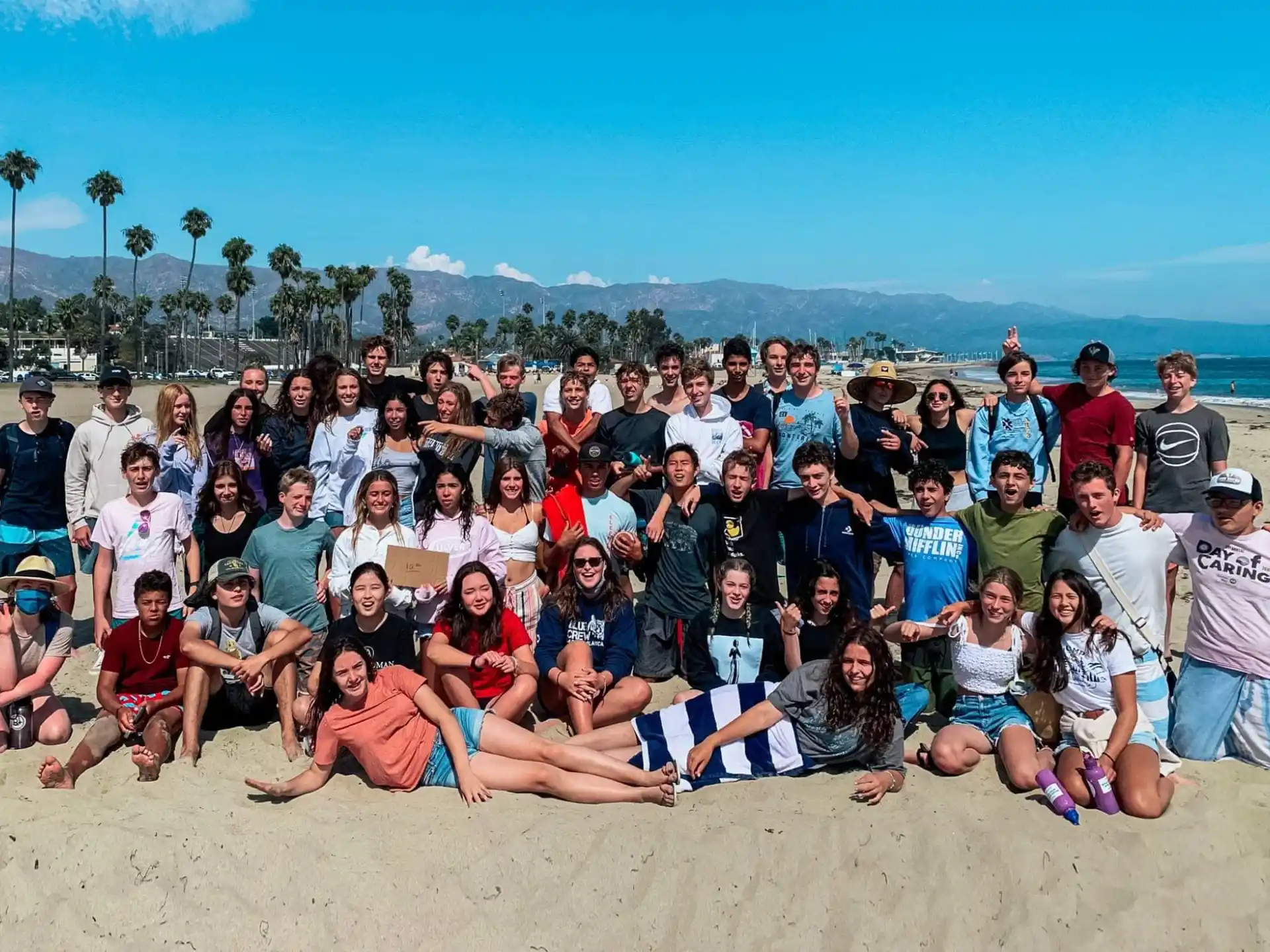 a group of people posing for a photo on a beach