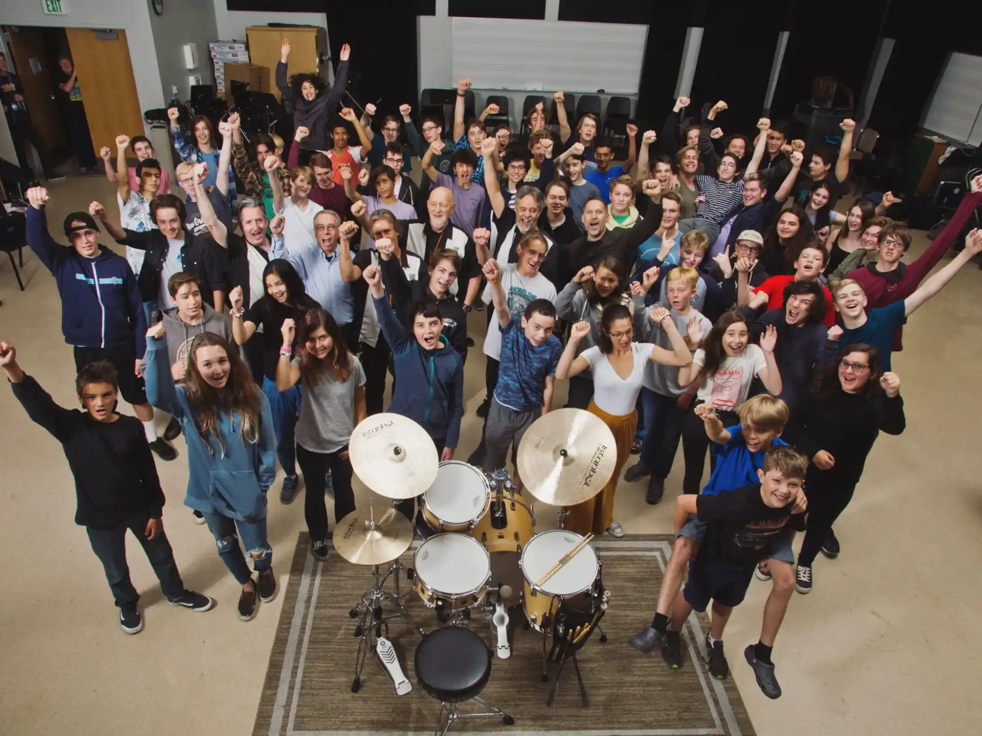 a group of people posing for a photo with drums