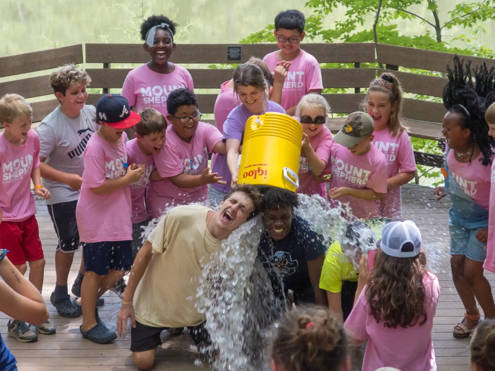 a group of people around a person in a bucket