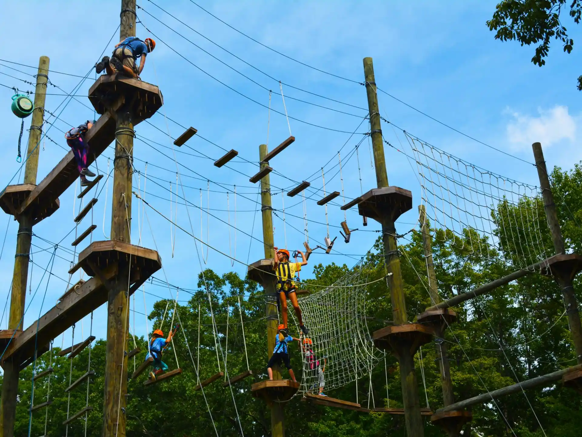 a group of people climbing a wooden structure