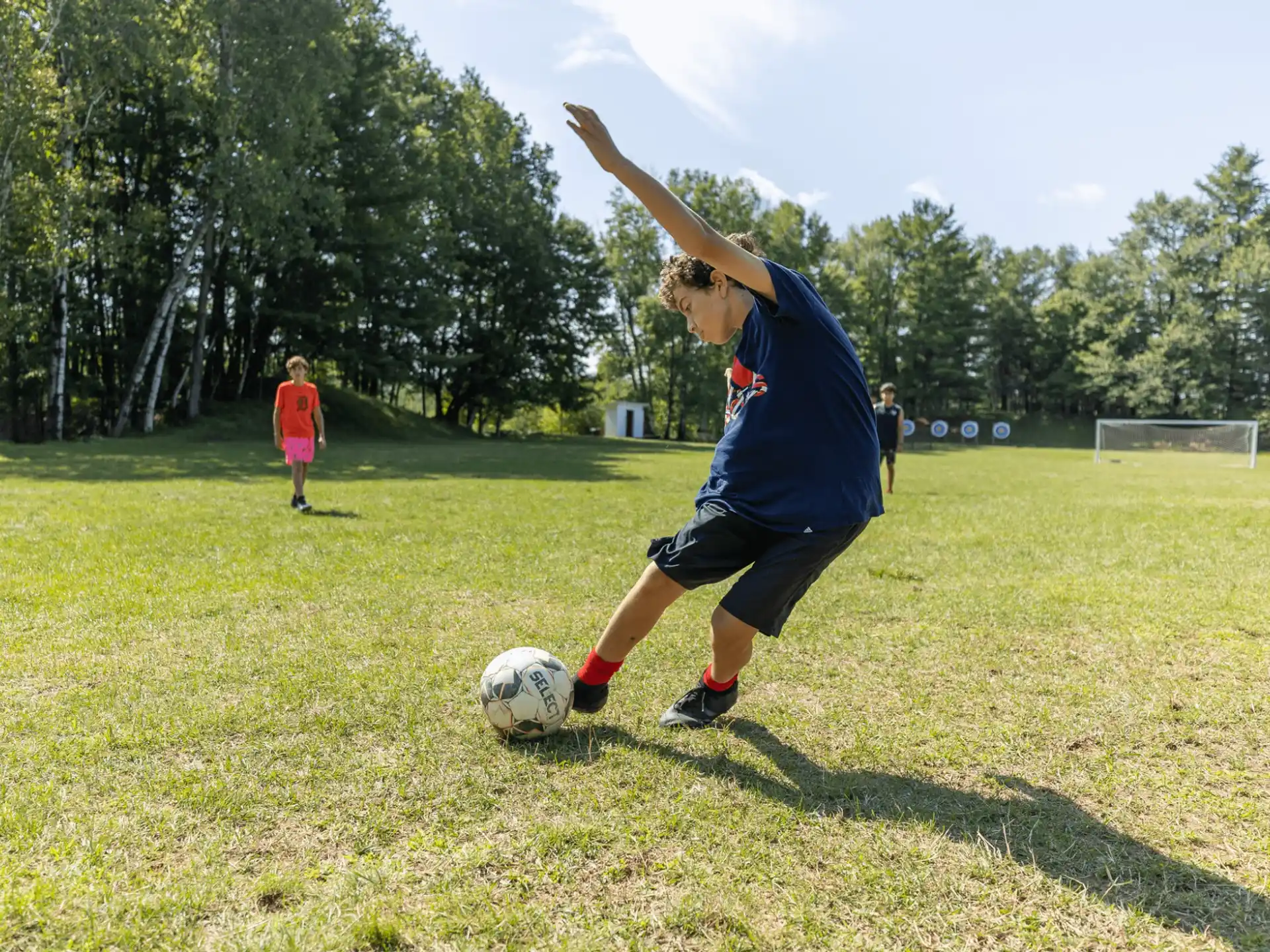 a man kicking a football ball