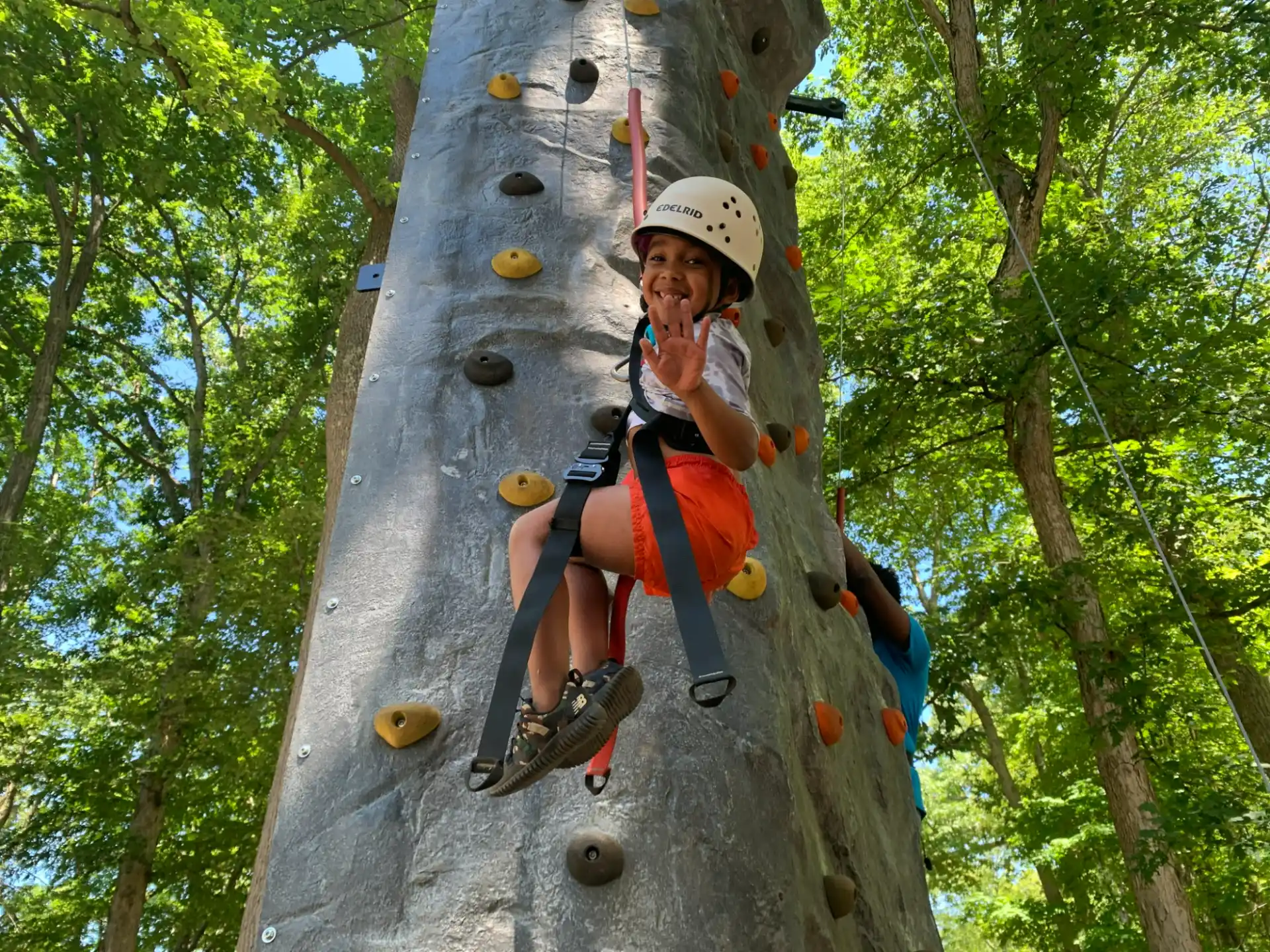 a boy climbing a rock wall
