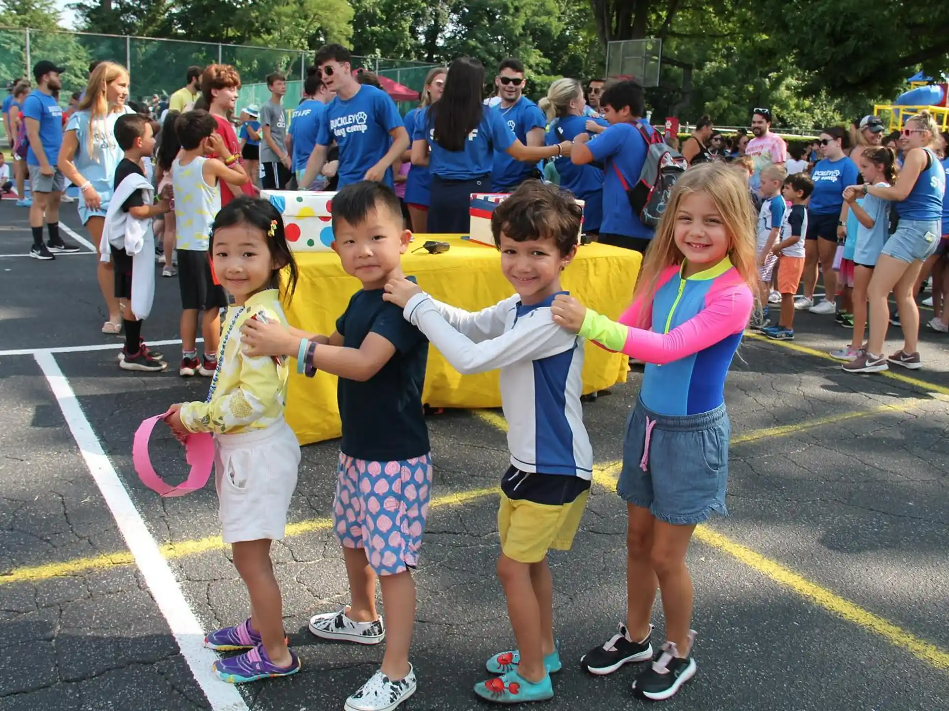 a group of children posing for a photo in front of a crowd