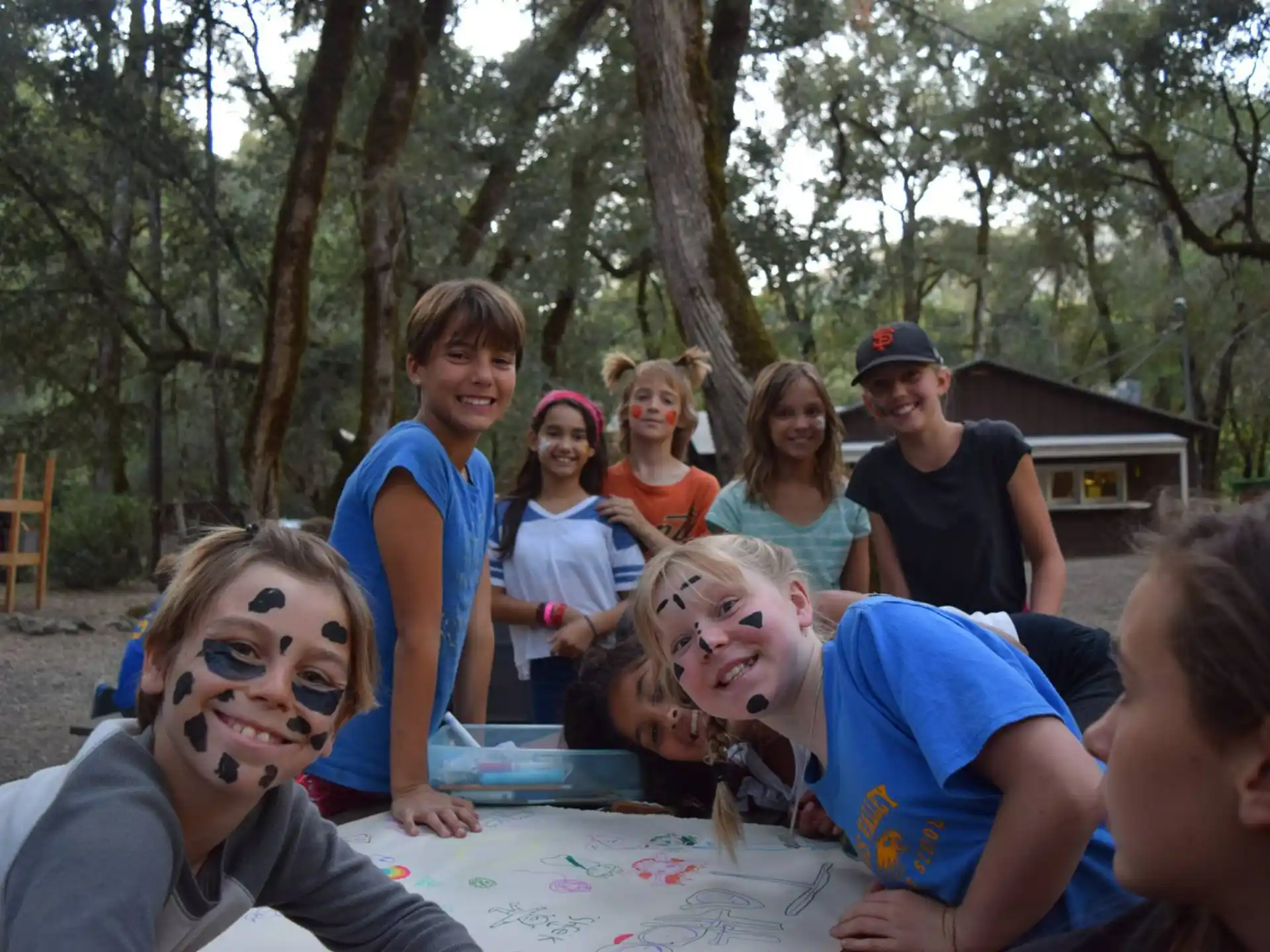 a group of people sitting at a table outside