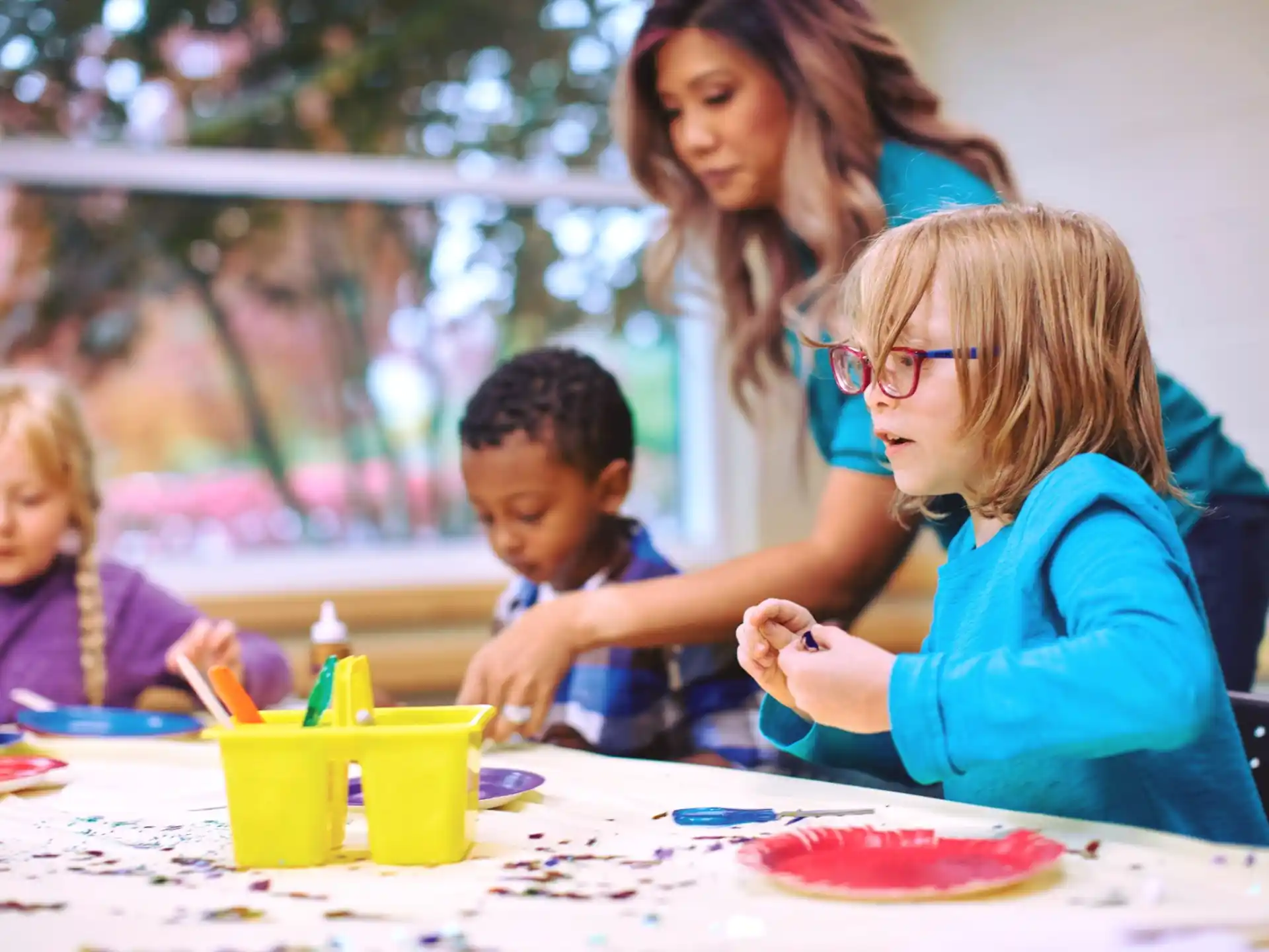 a group of children sitting at a table