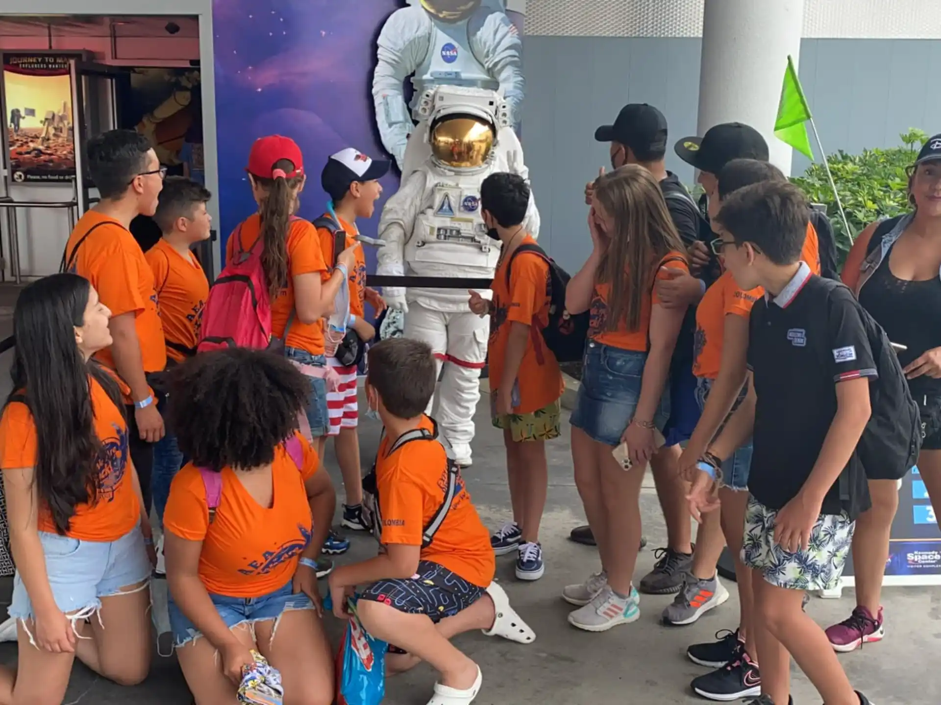 a group of people standing around a statue