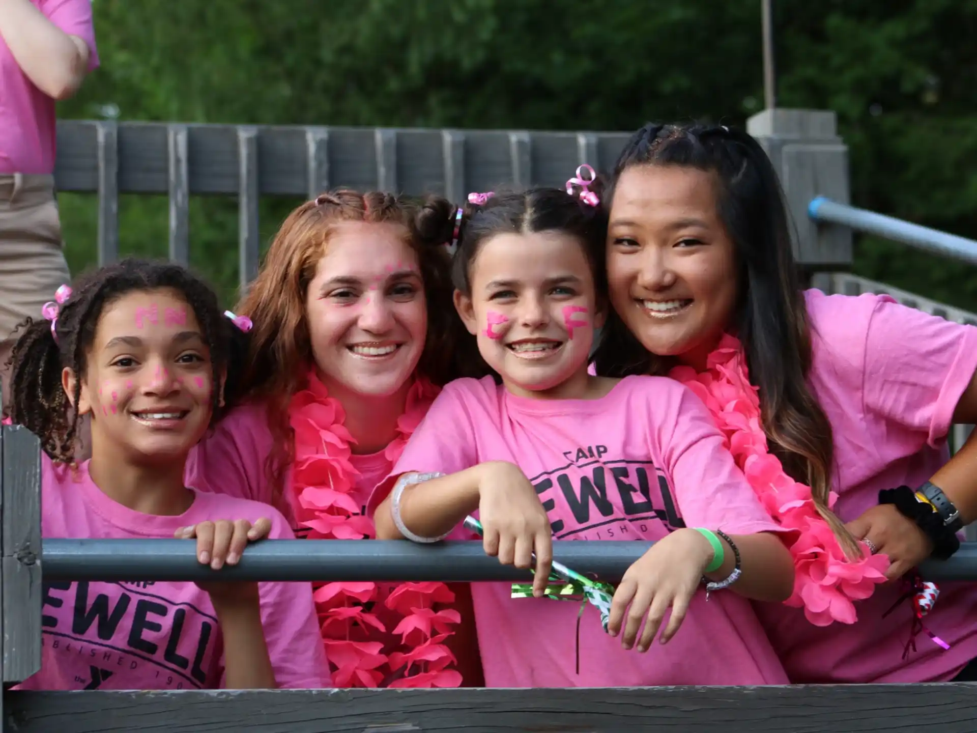 a group of girls in pink shirts