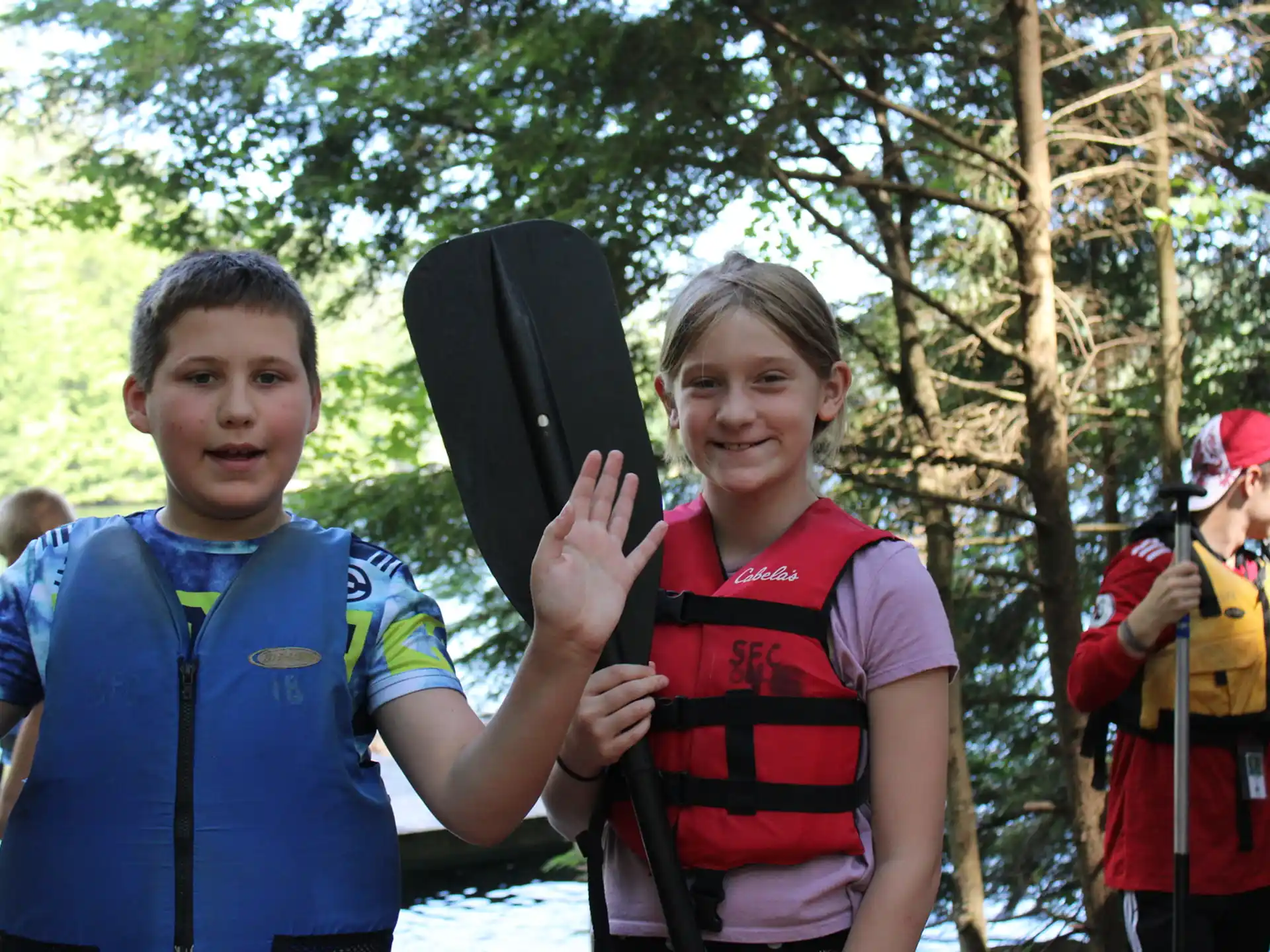 a boy and girl holding a gun