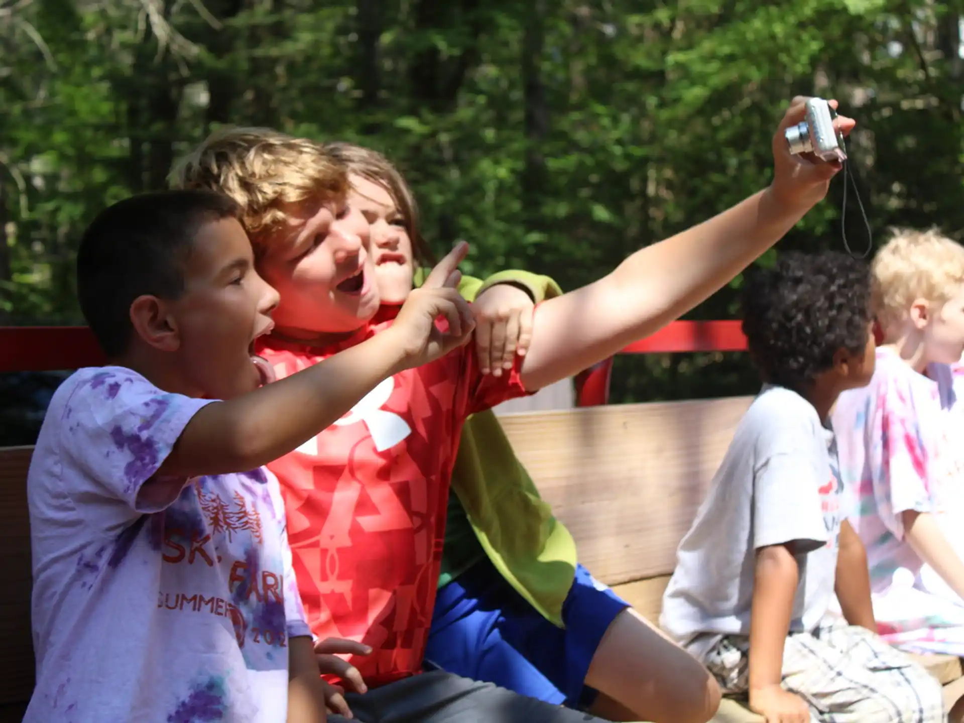 a group of children playing with a toy gun