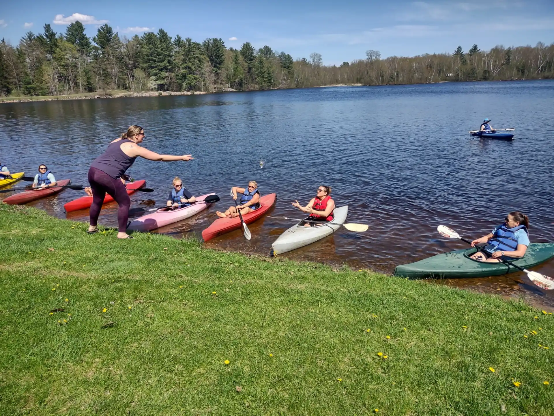 a group of people on canoes in a lake
