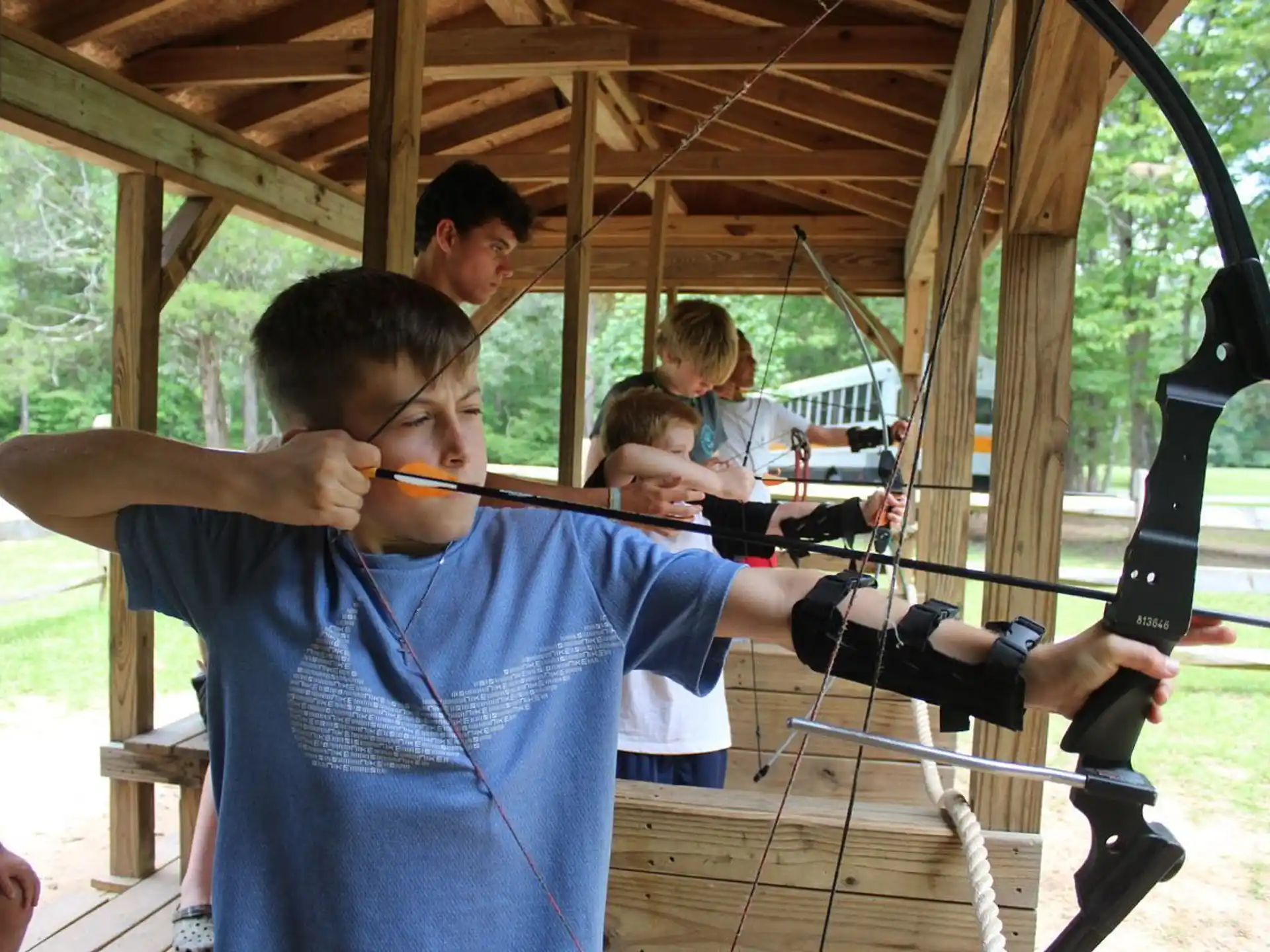 a boy holding a bow and arrow