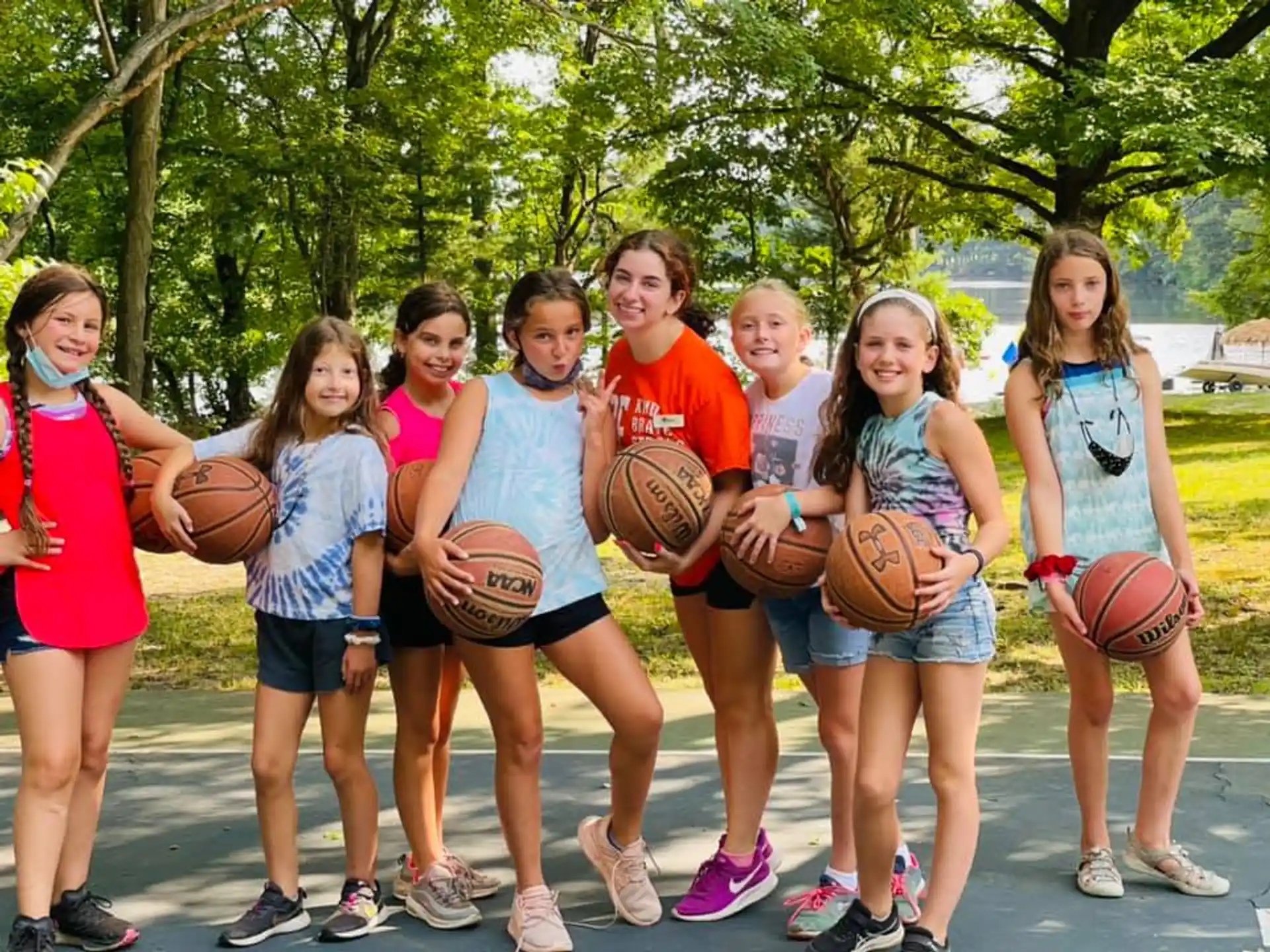 a group of girls holding basketballs