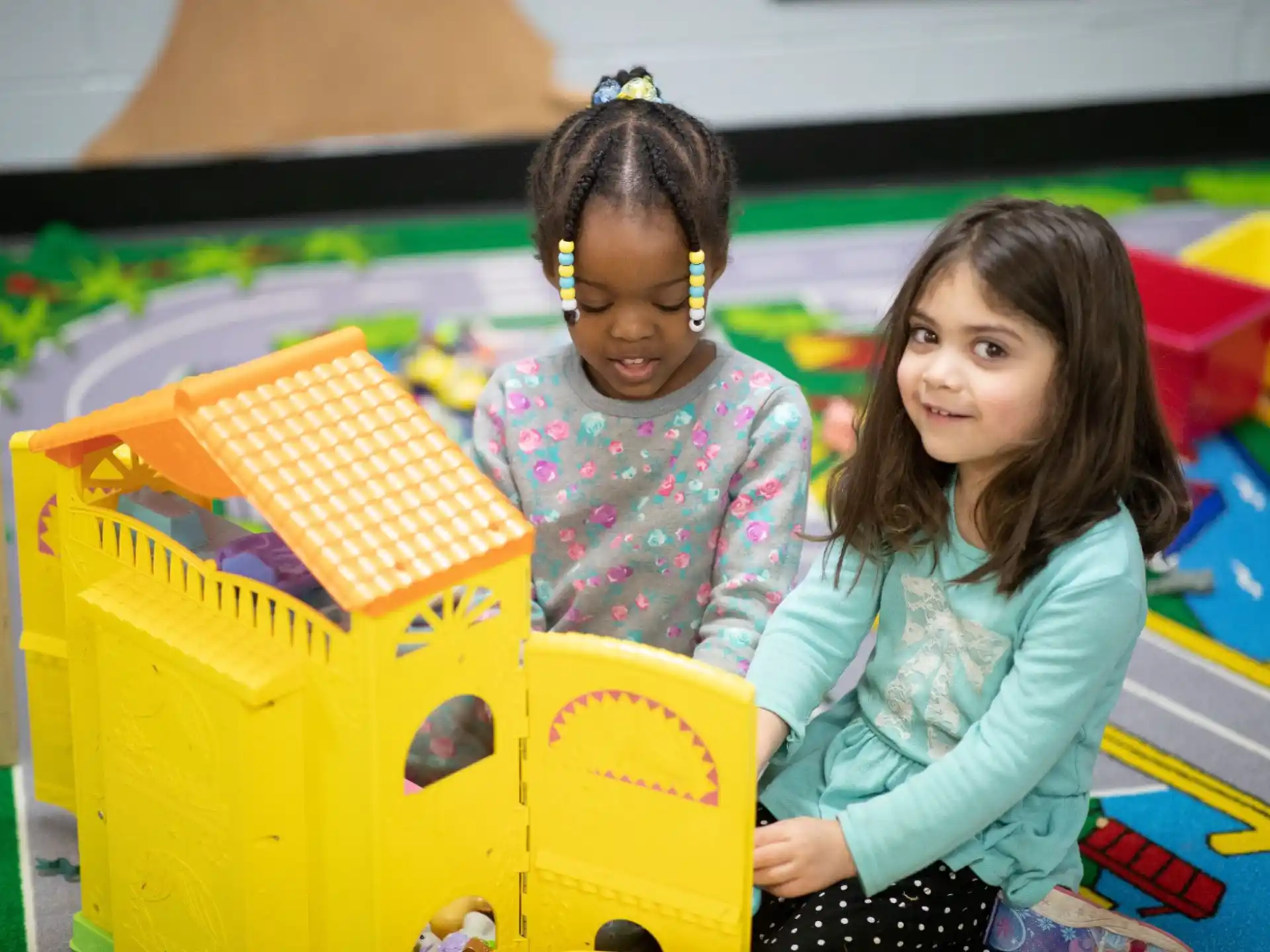 a couple of girls playing with a toy