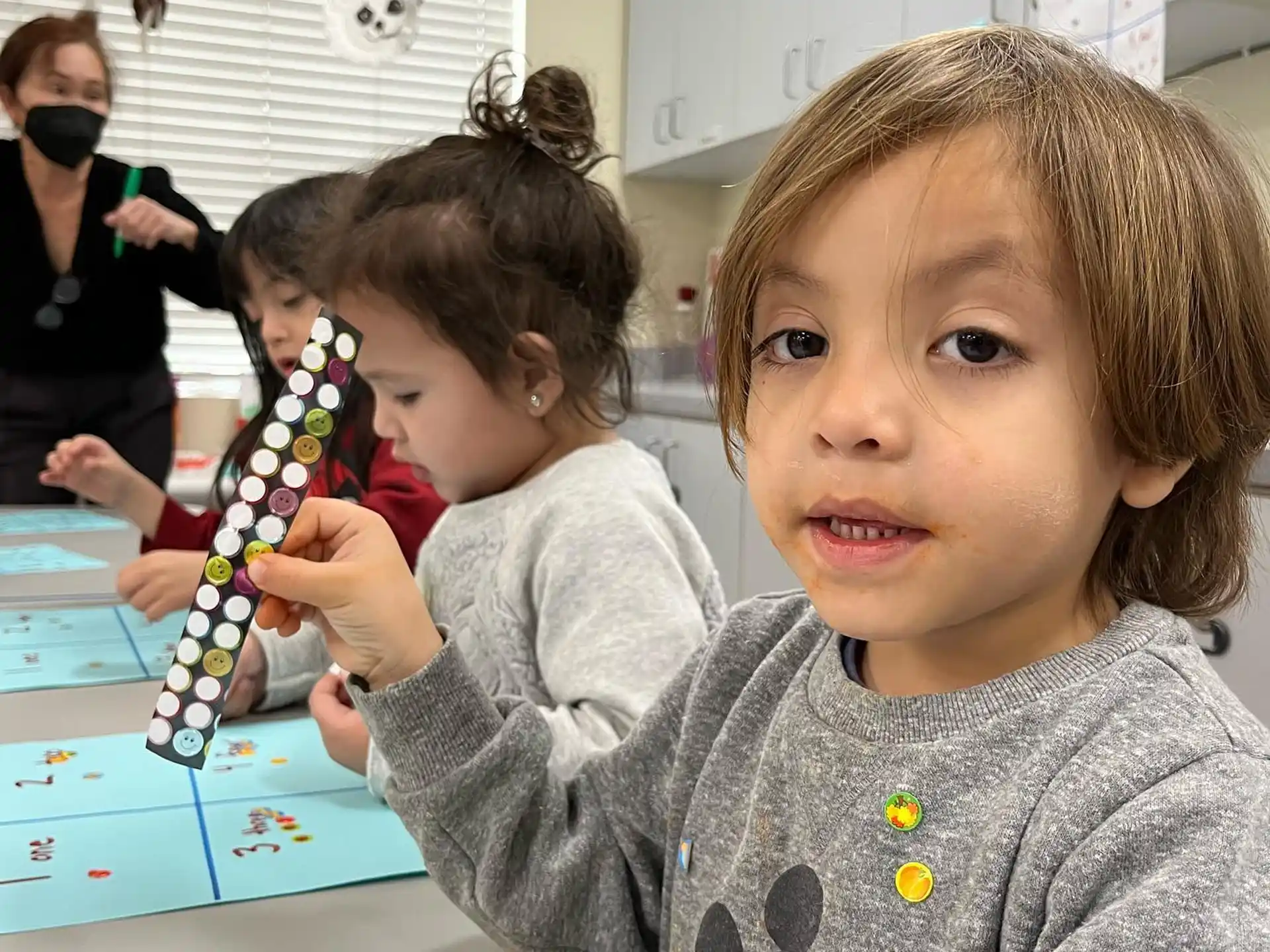 a young girl holding a toy