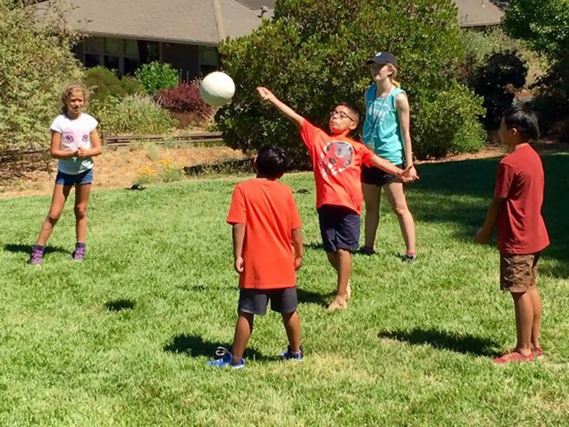 a group of kids playing with a ball