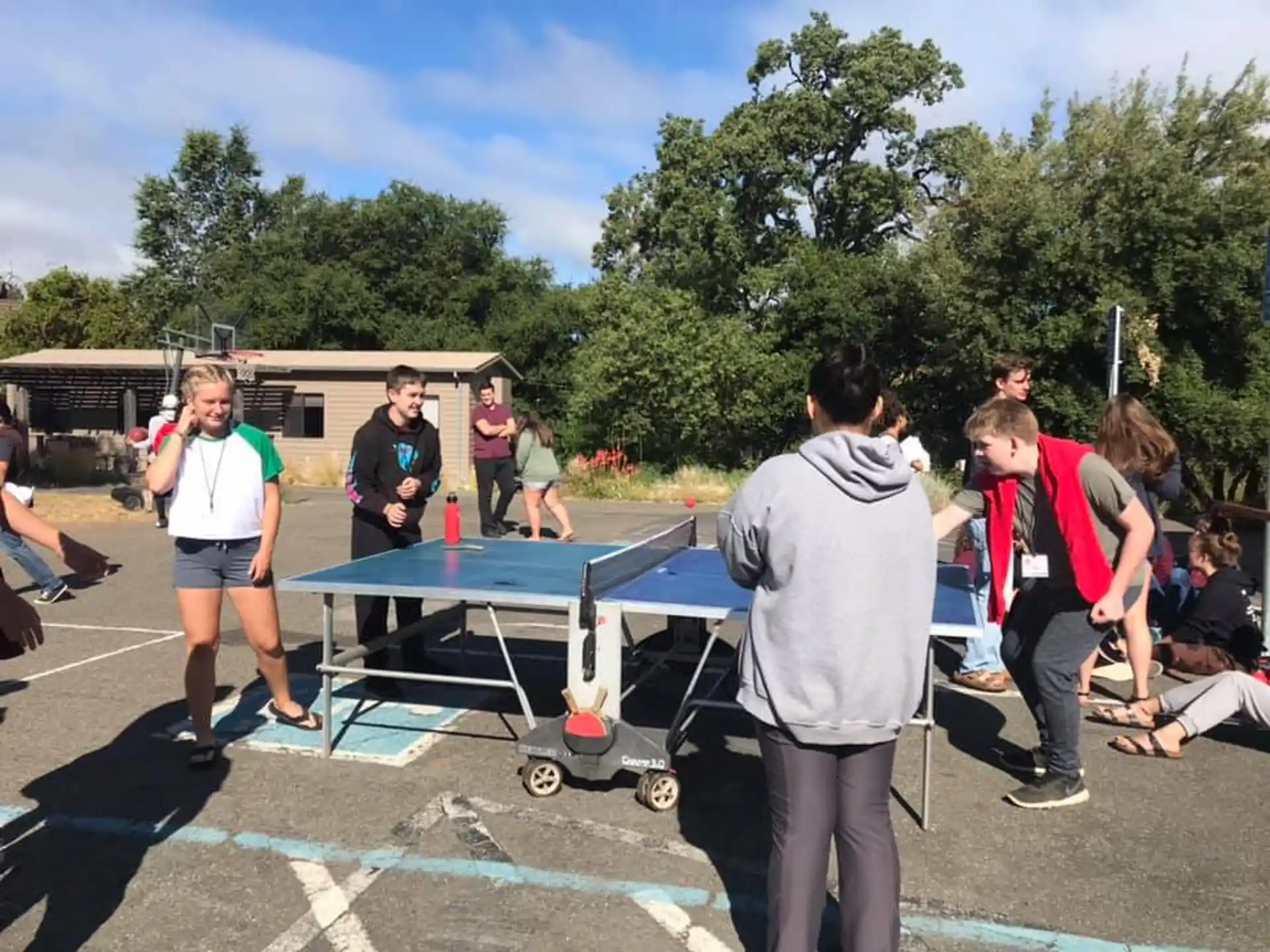 a group of people playing ping pong