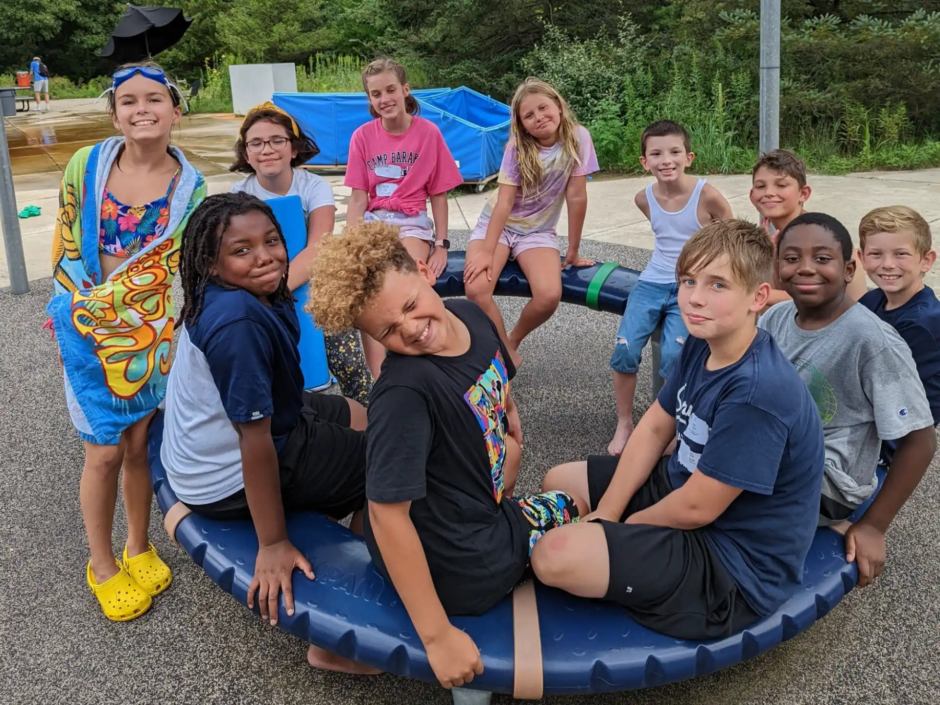 a group of people sitting on a blue mat