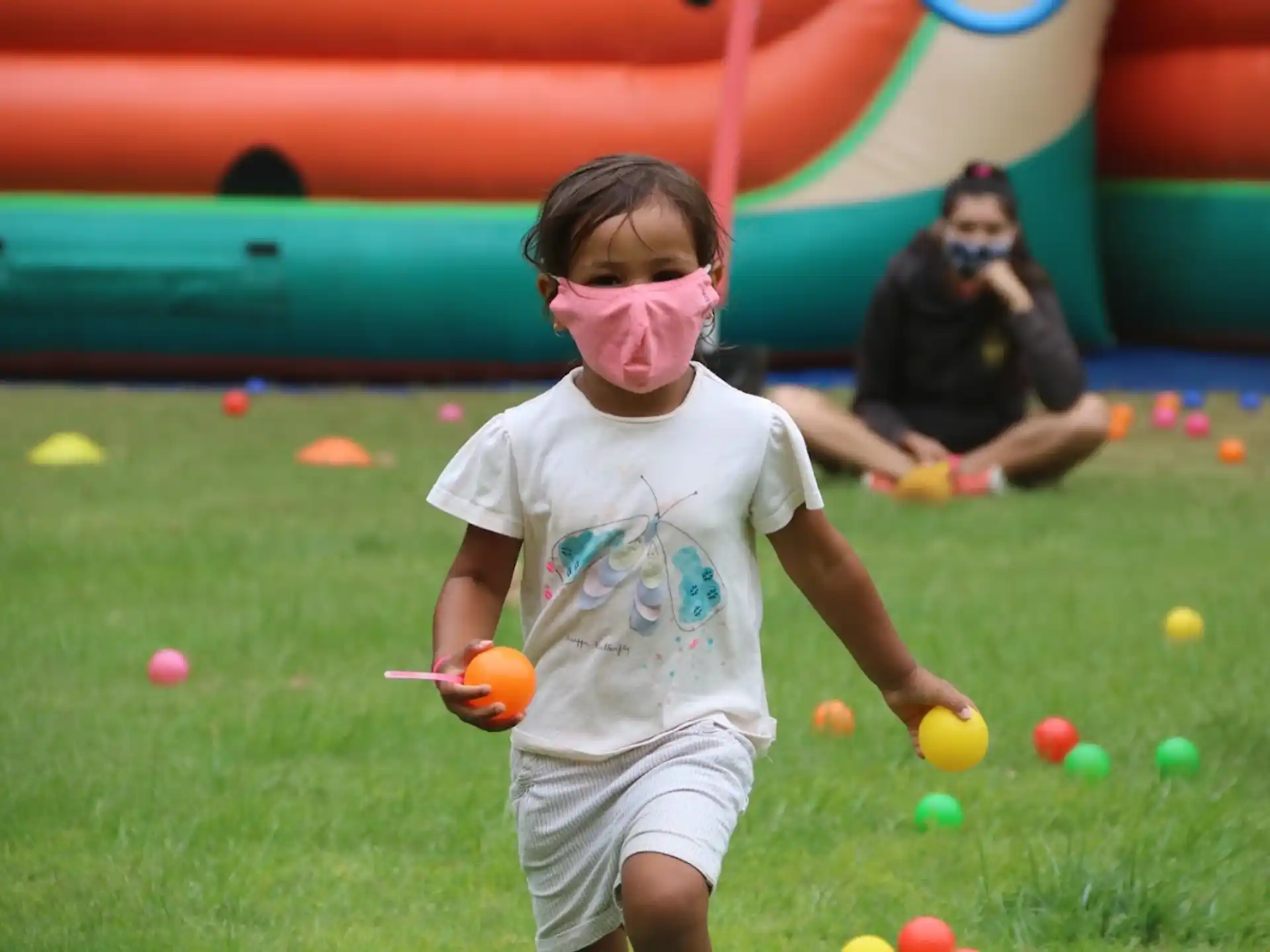 a girl playing with balls