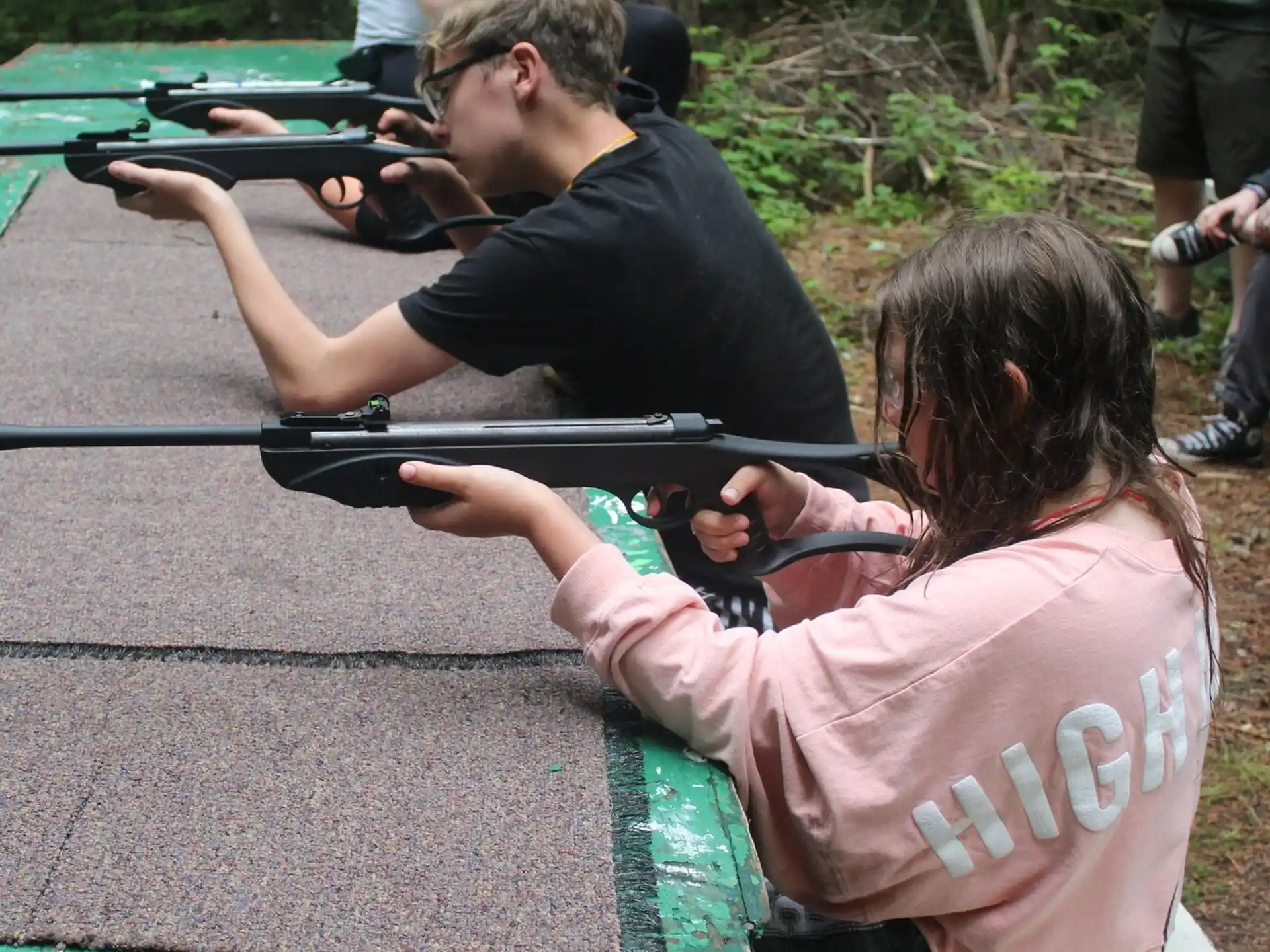 a man and a woman shooting guns