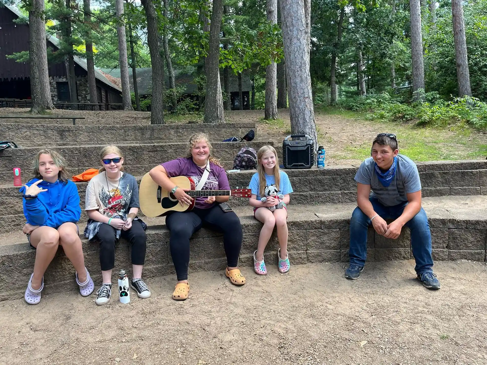 a group of people sitting on a bench playing instruments