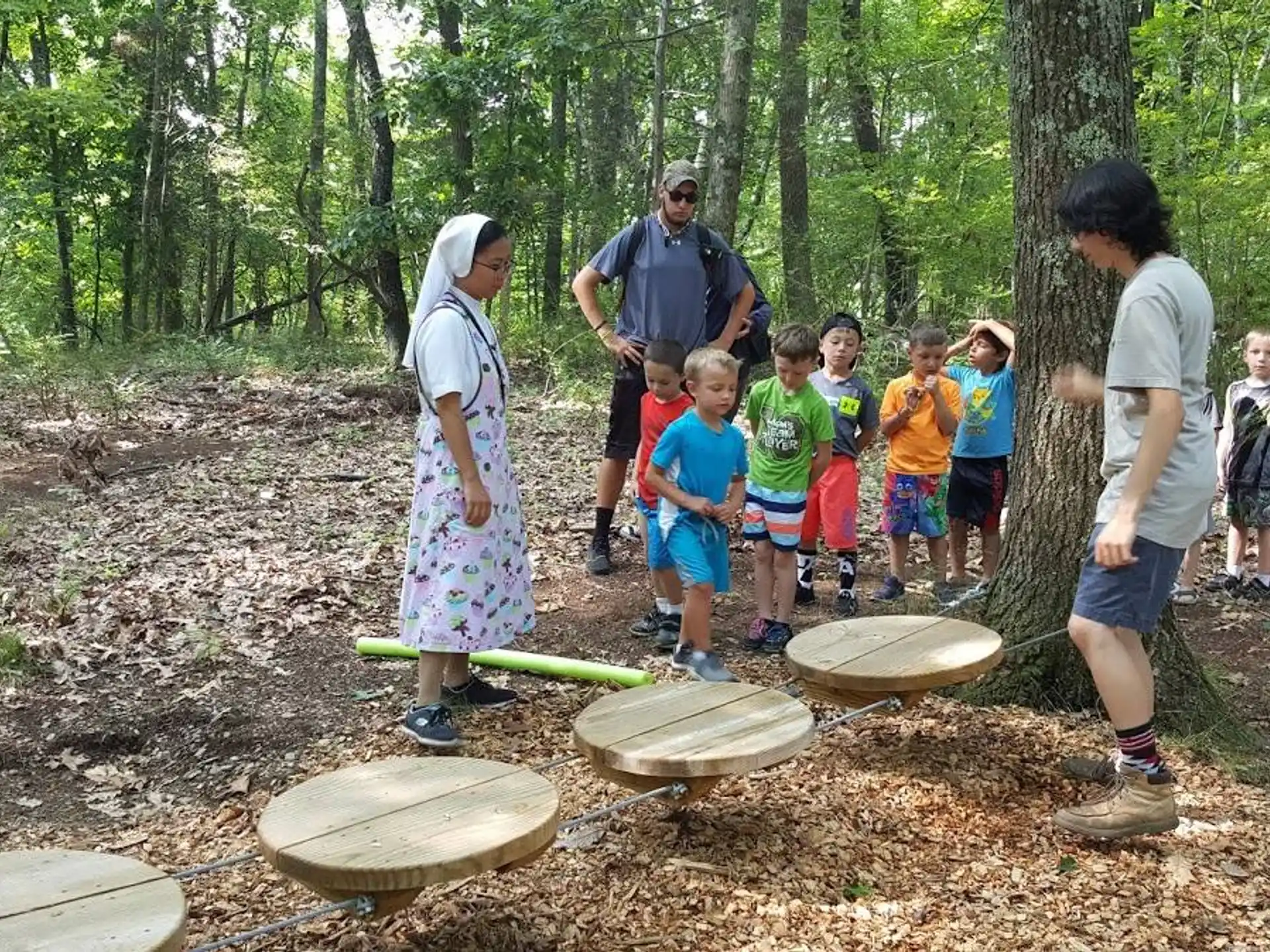 a group of people standing in the woods