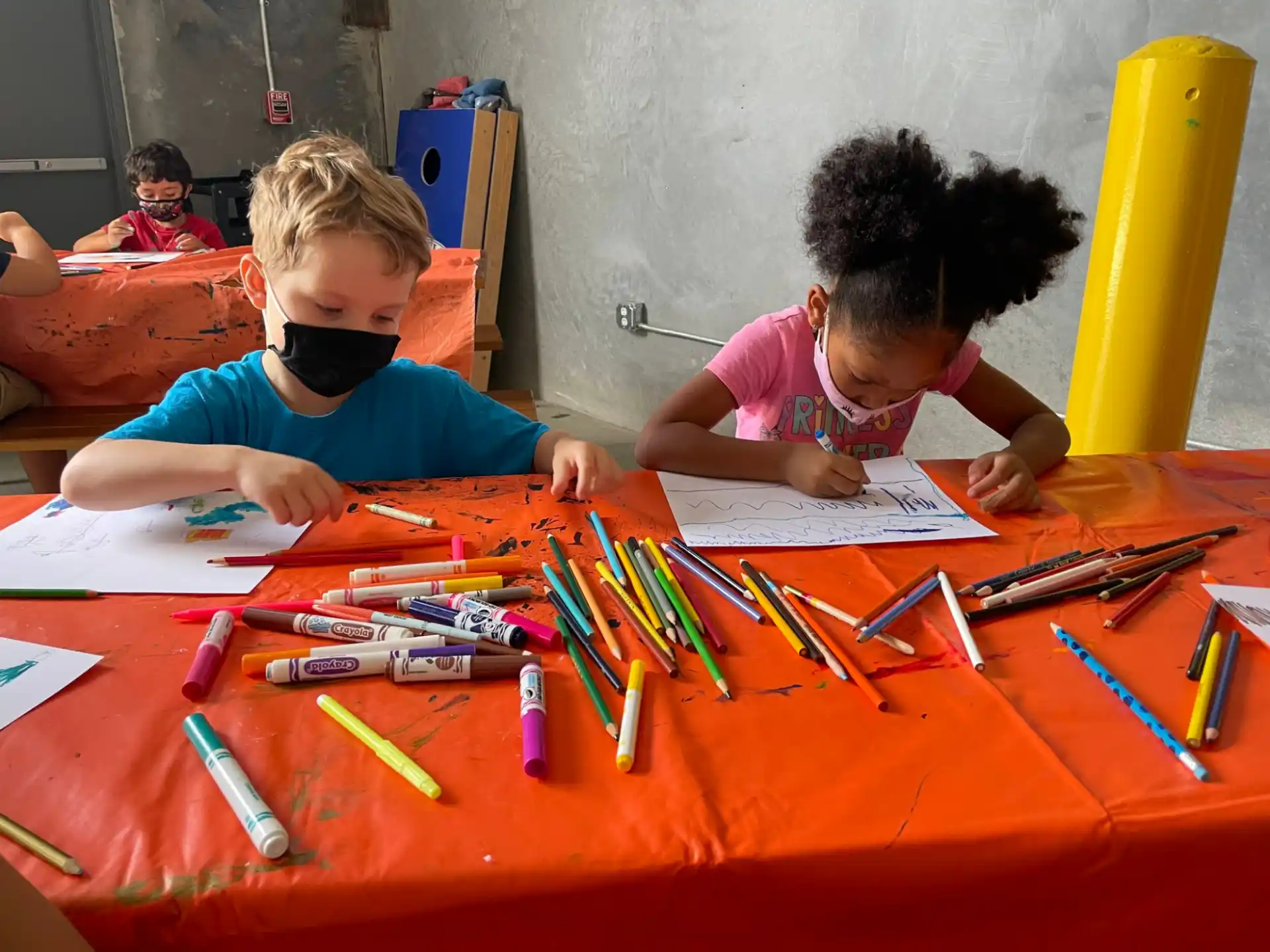a few children sitting at a table
