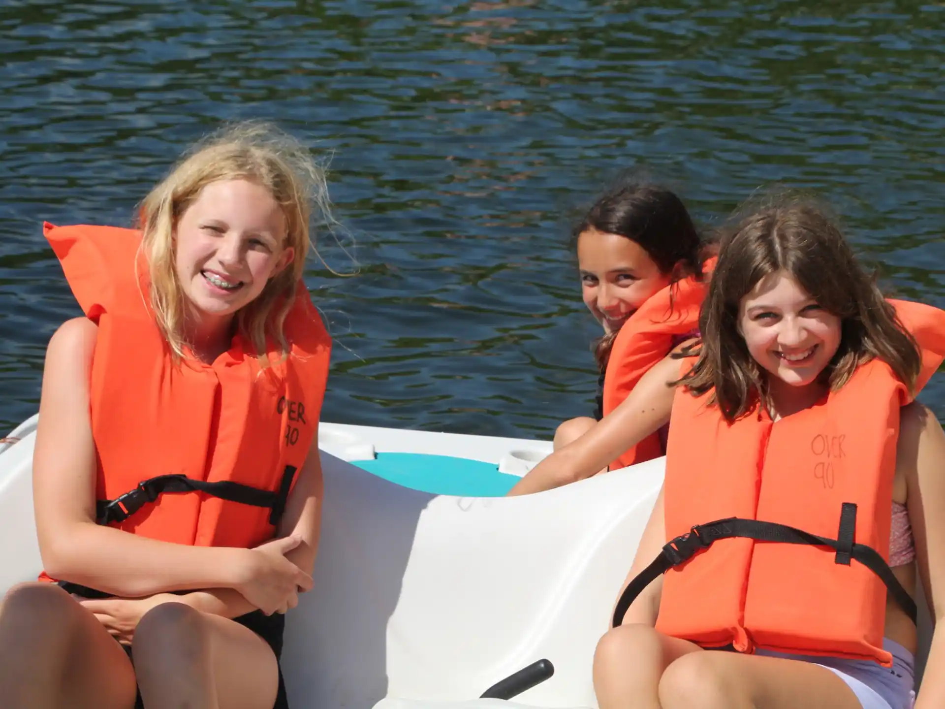 a group of people in life jackets on a boat