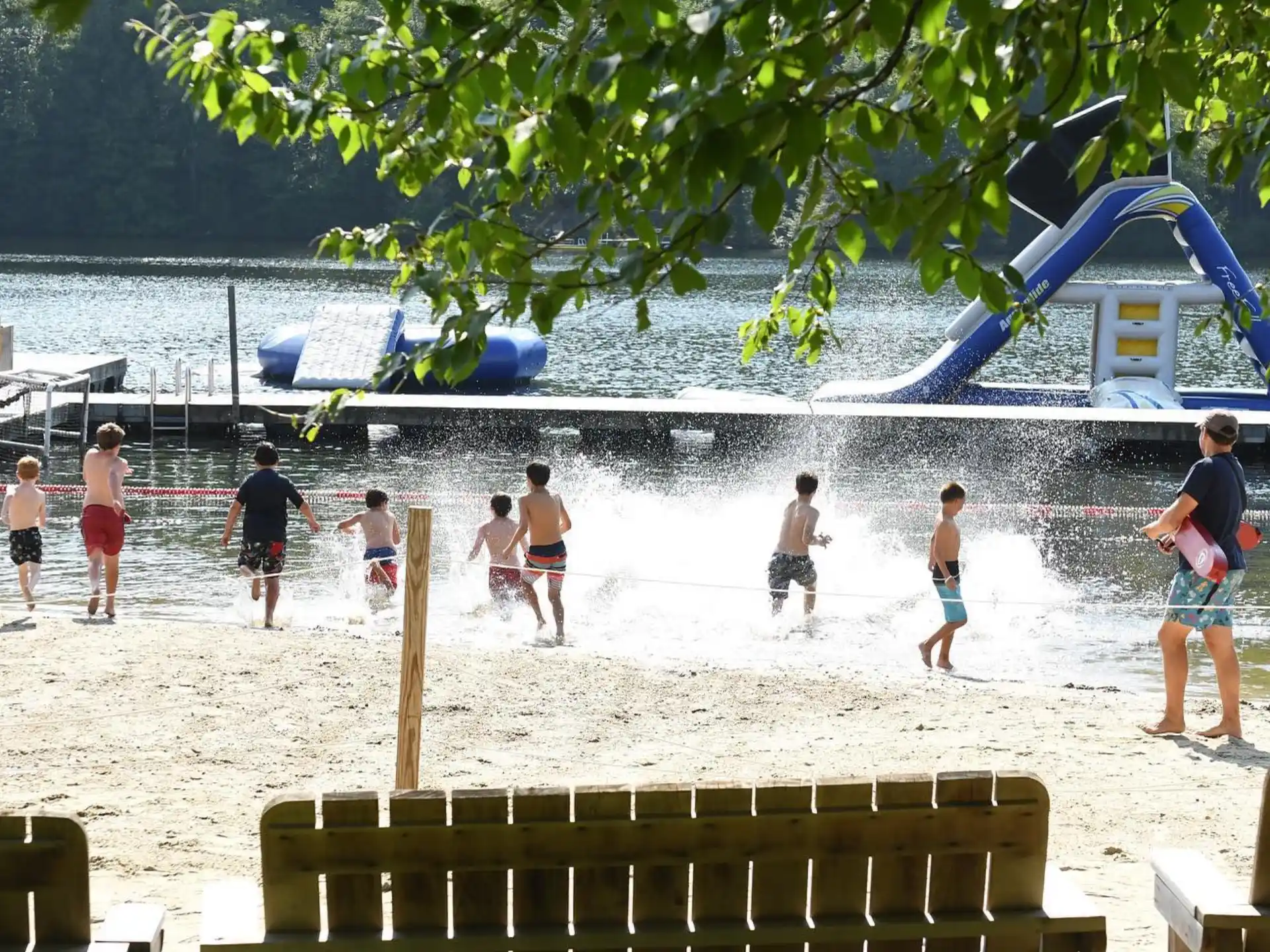 a group of people playing volleyball on a beach