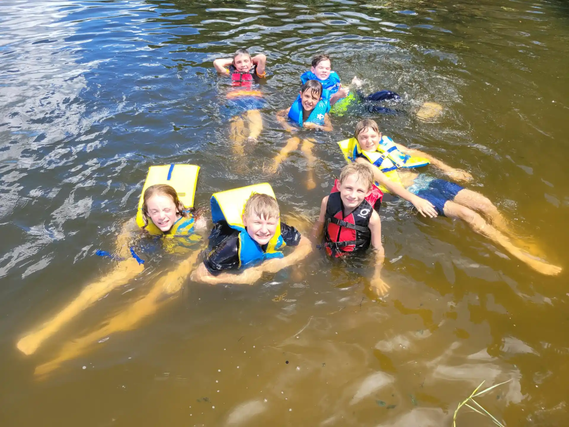 a group of kids in the water
