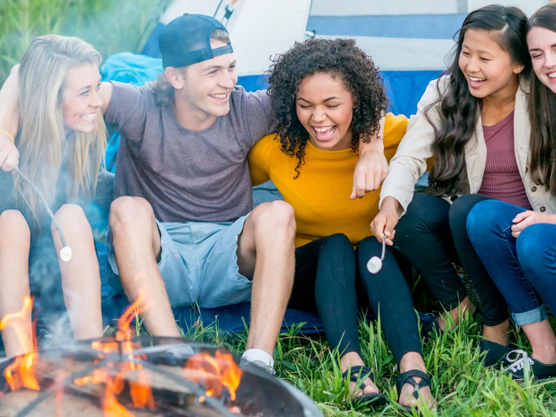 a group of people sitting around a fire