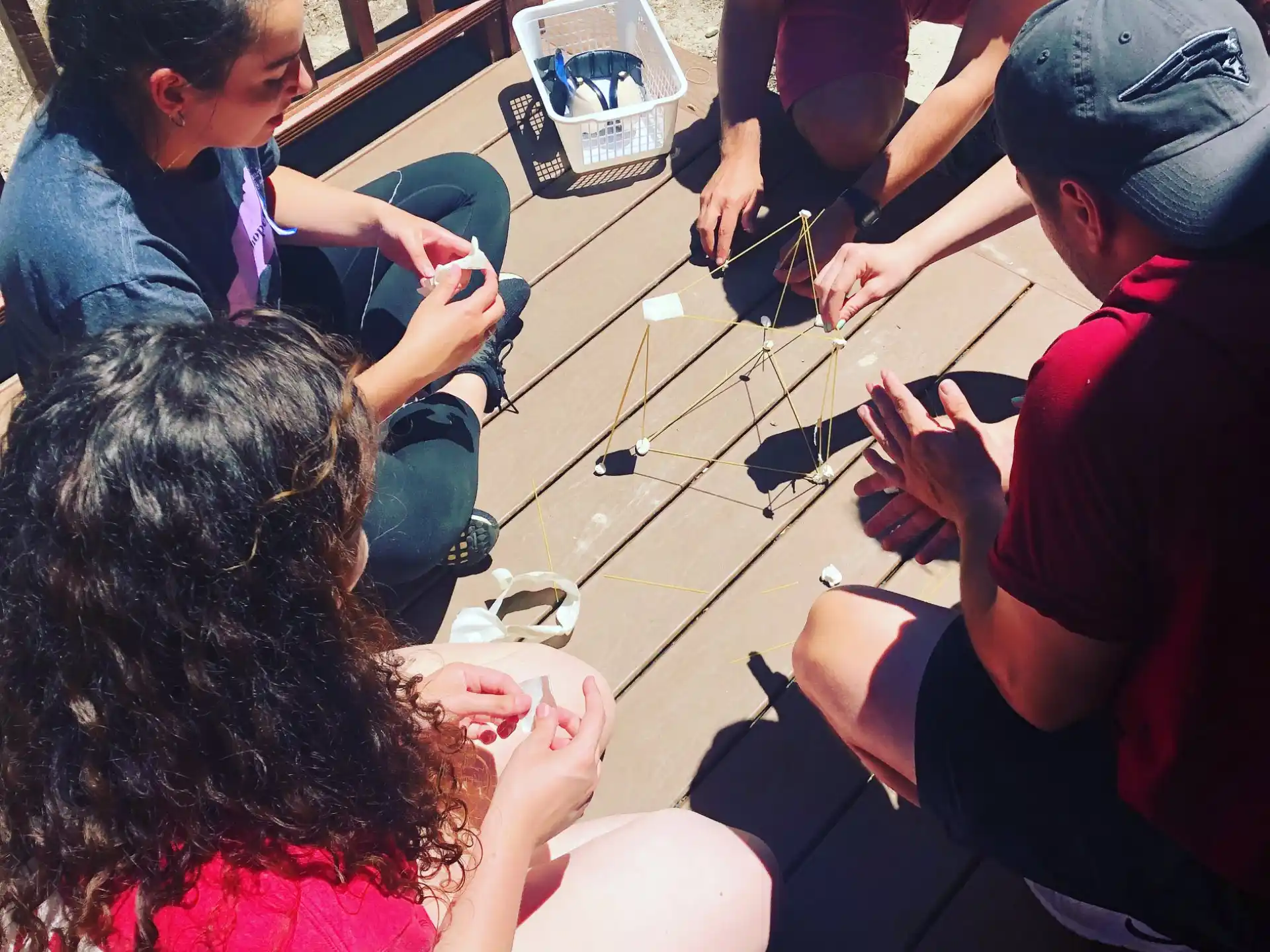 a group of people sitting around a table playing a game