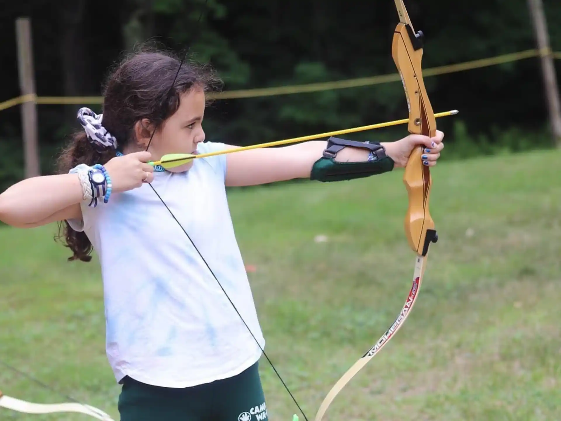 a girl holding a bow and arrow