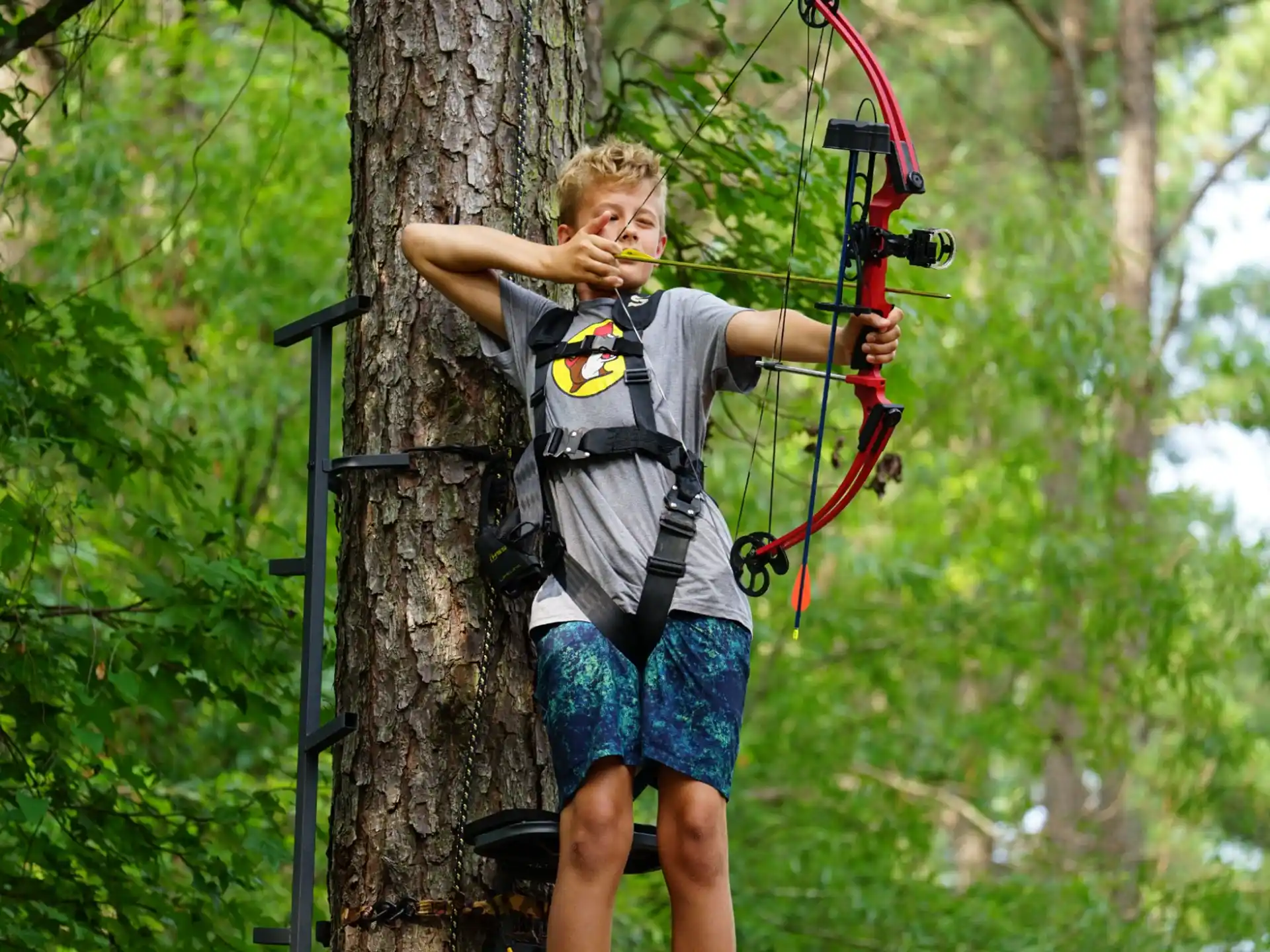 a boy holding a bow and arrow