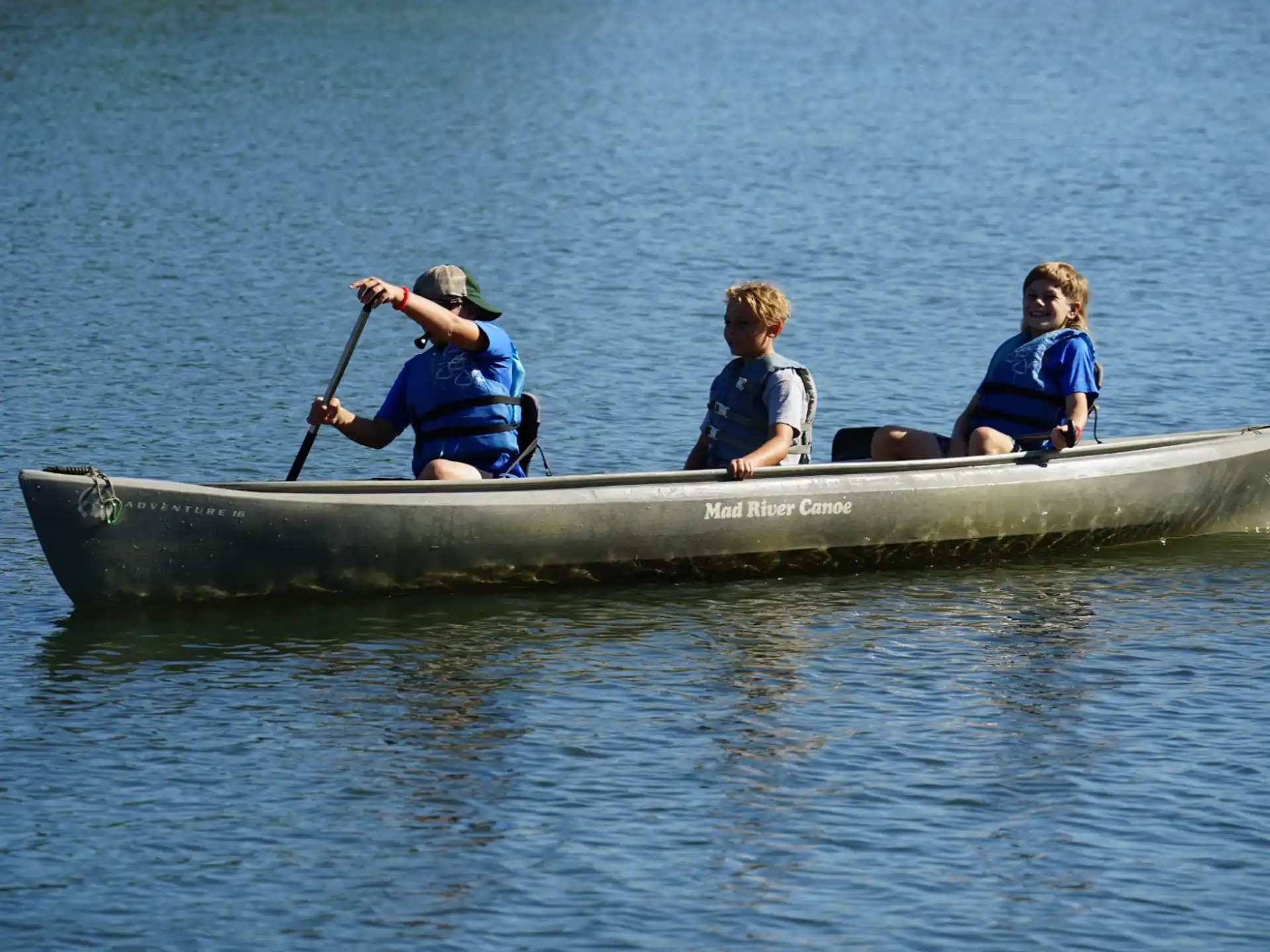 a group of people paddle a canoe