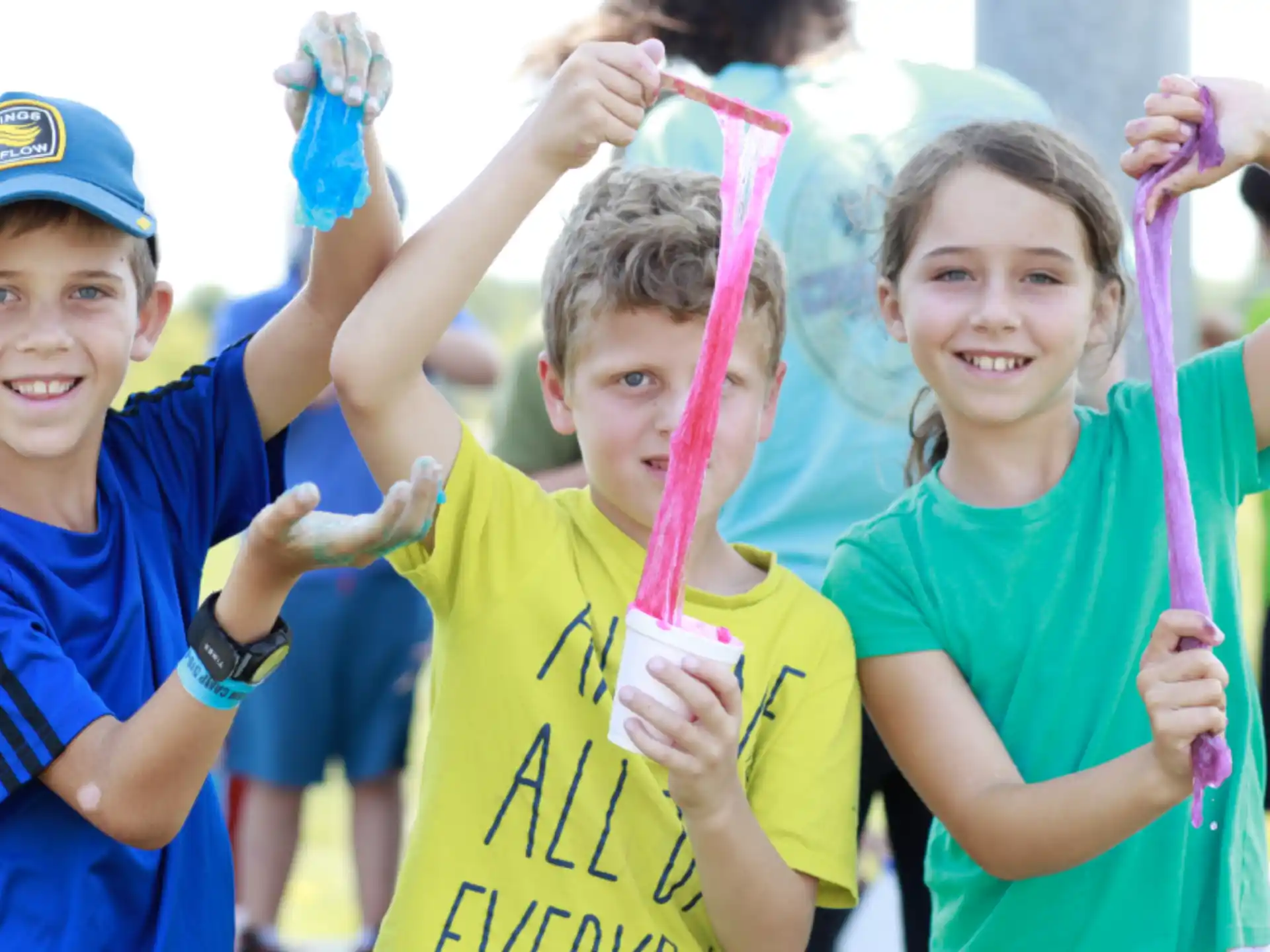 a group of children holding up blue and yellow objects