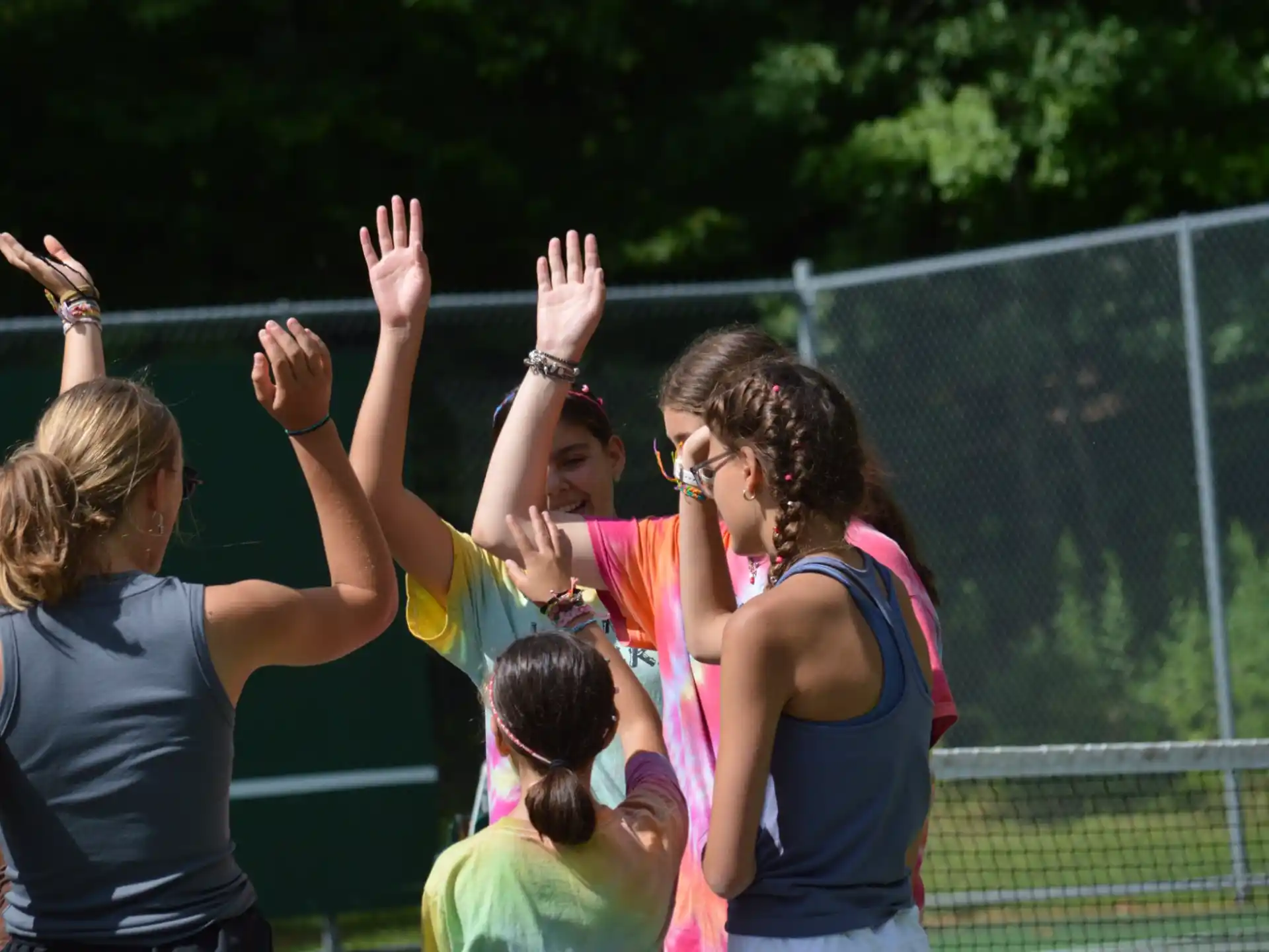 a group of girls raising their hands