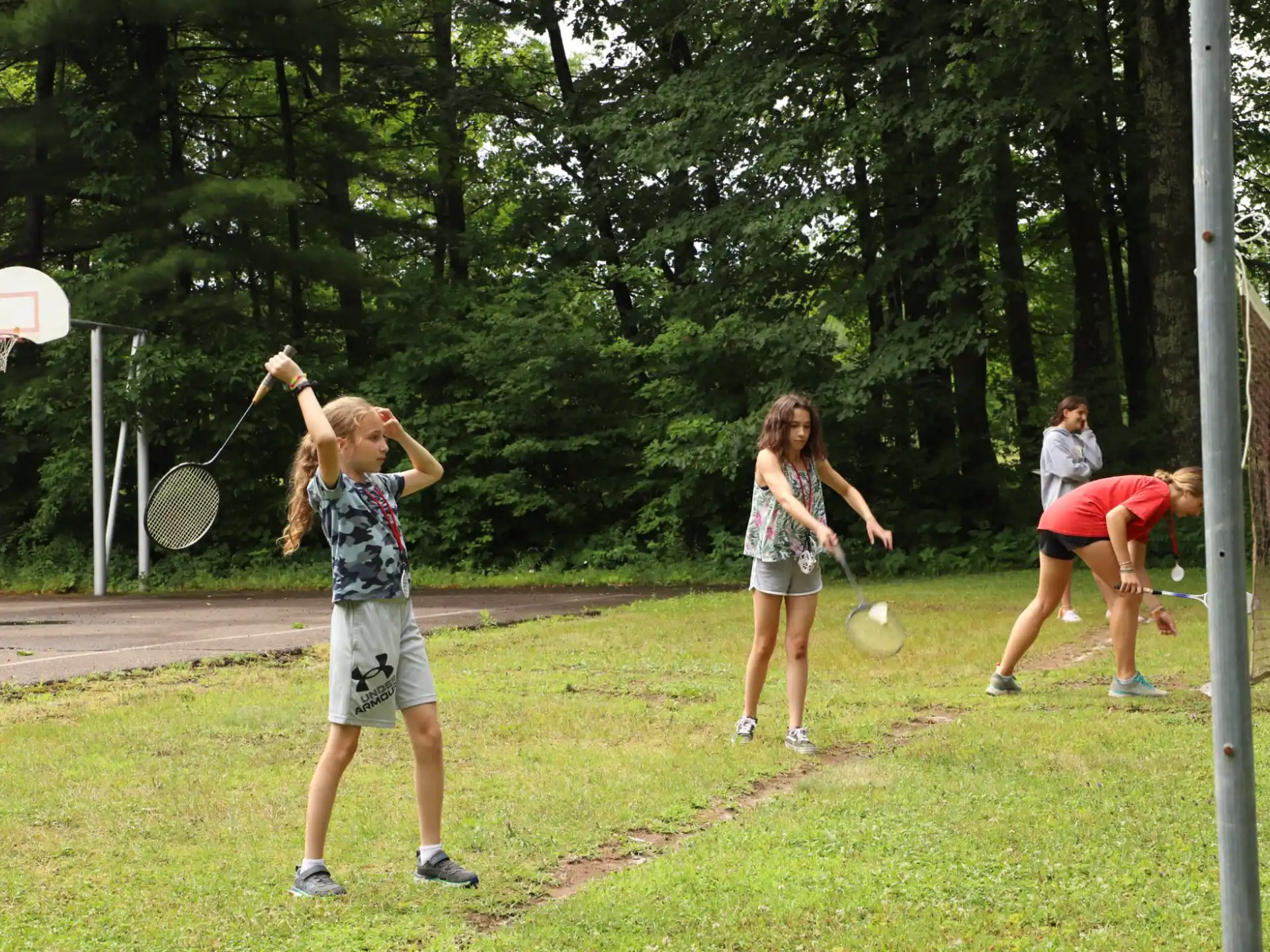 a group of people play tennis