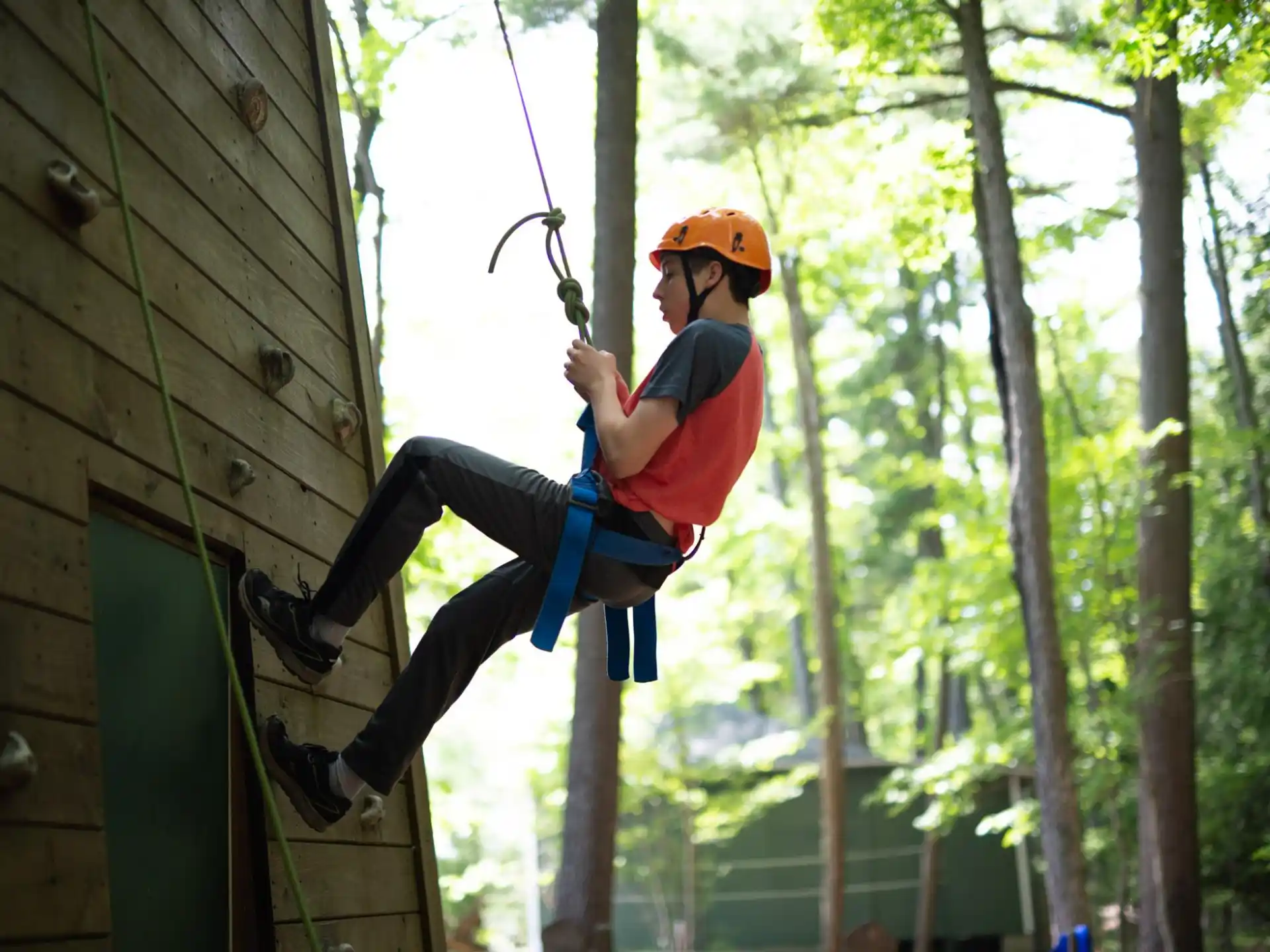 a person climbing a rope
