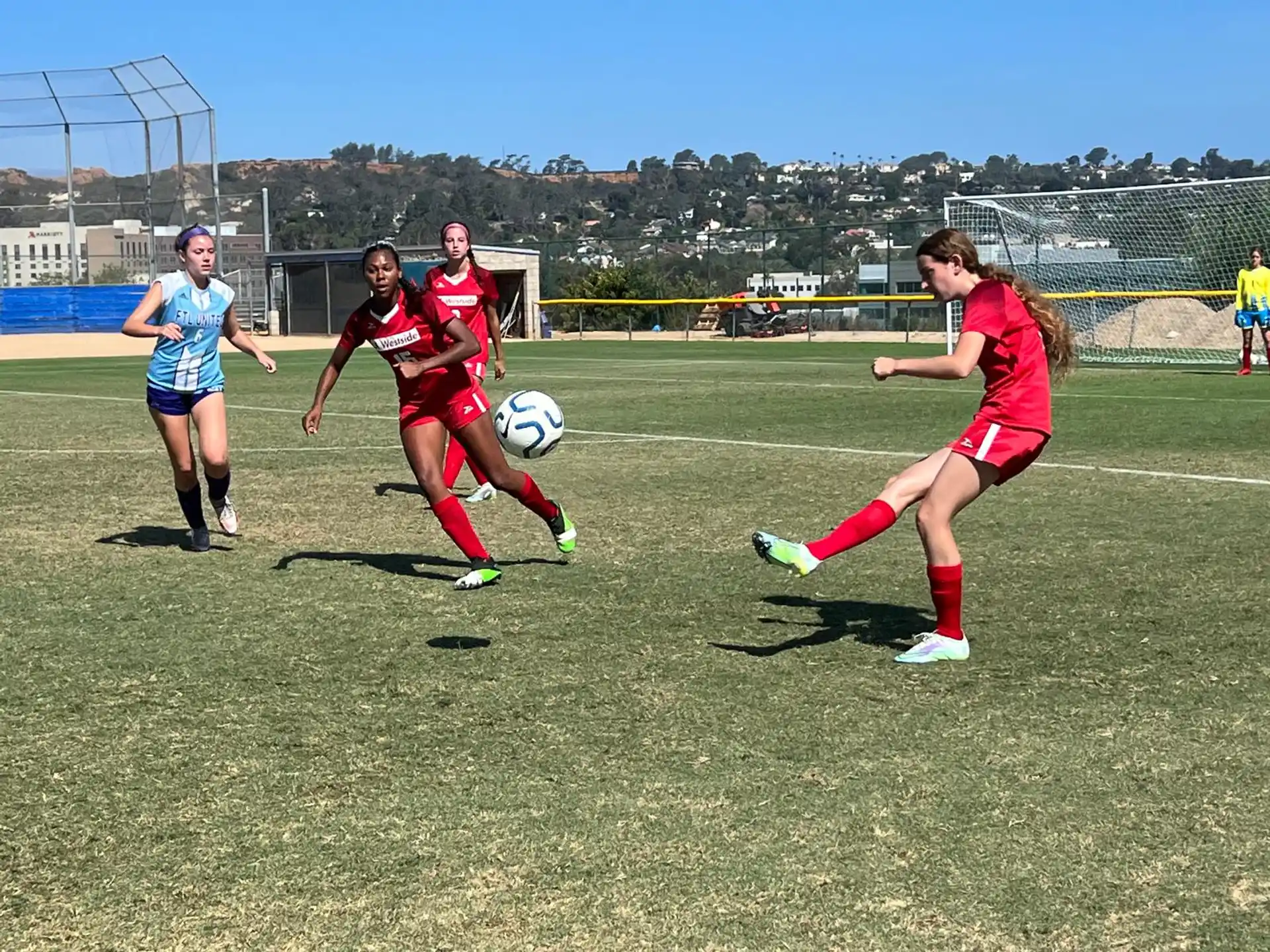 girls playing football on a field