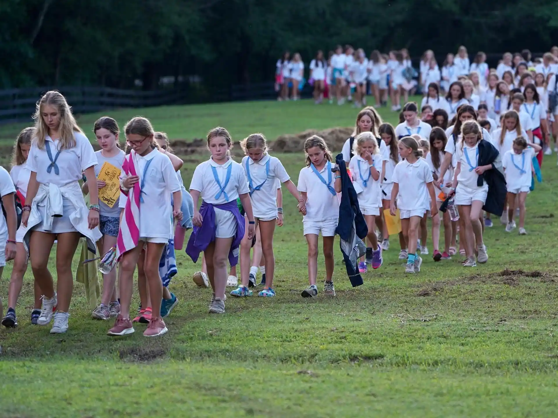 a group of children in matching t-shirts standing on a field