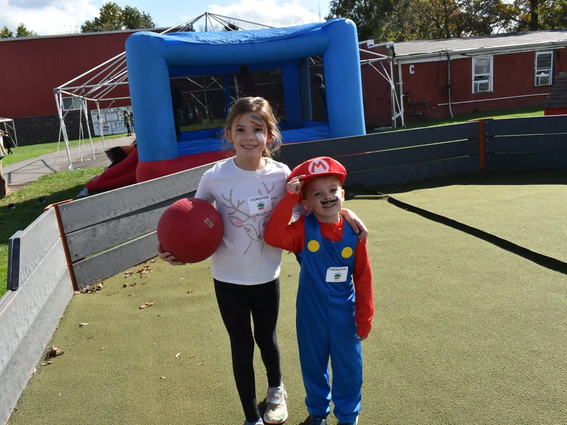 a person and two children holding a ball