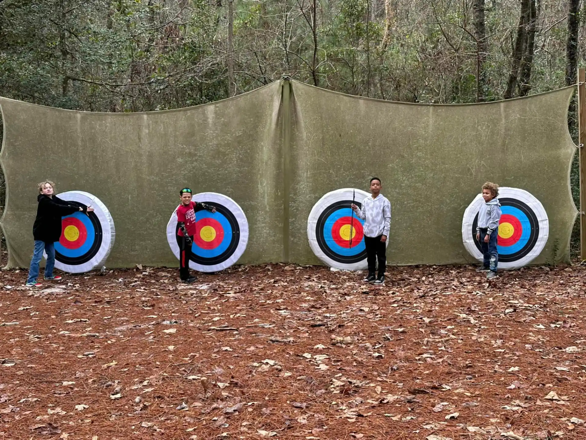 a group of people holding large blue and white targets