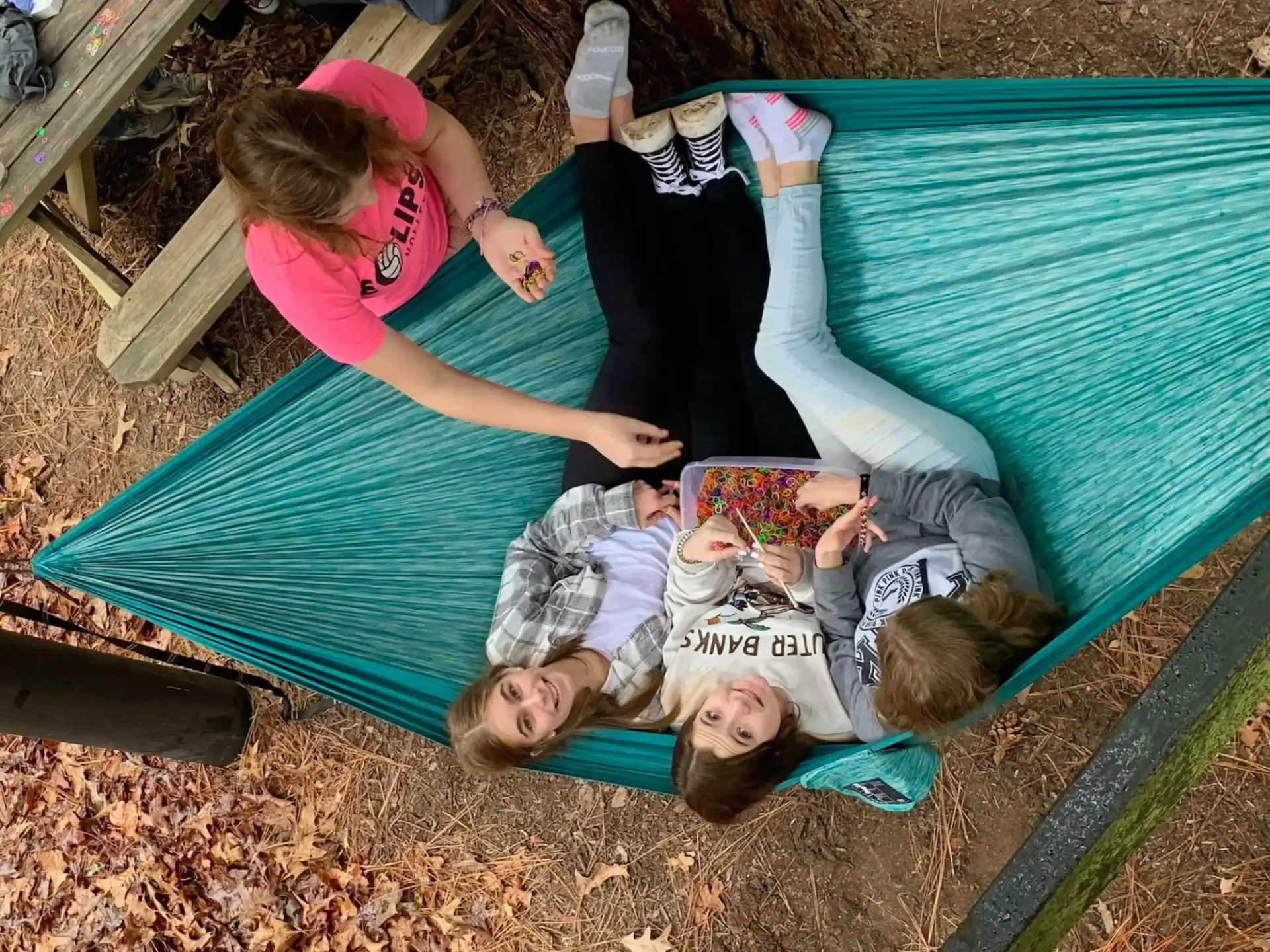 a group of people lying on a mat outside