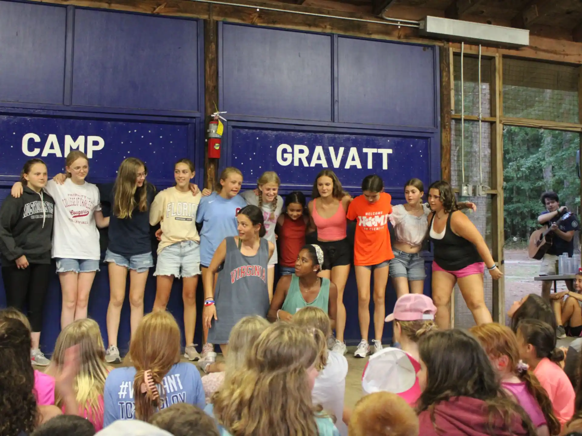 a group of people standing in front of a stage