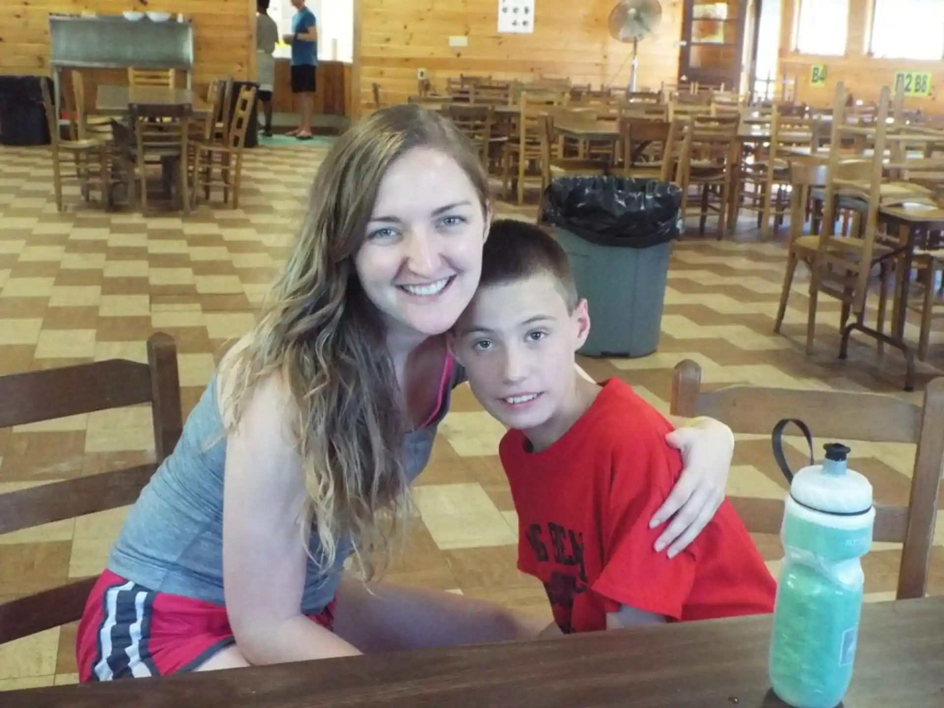 a person and a boy sitting at a table