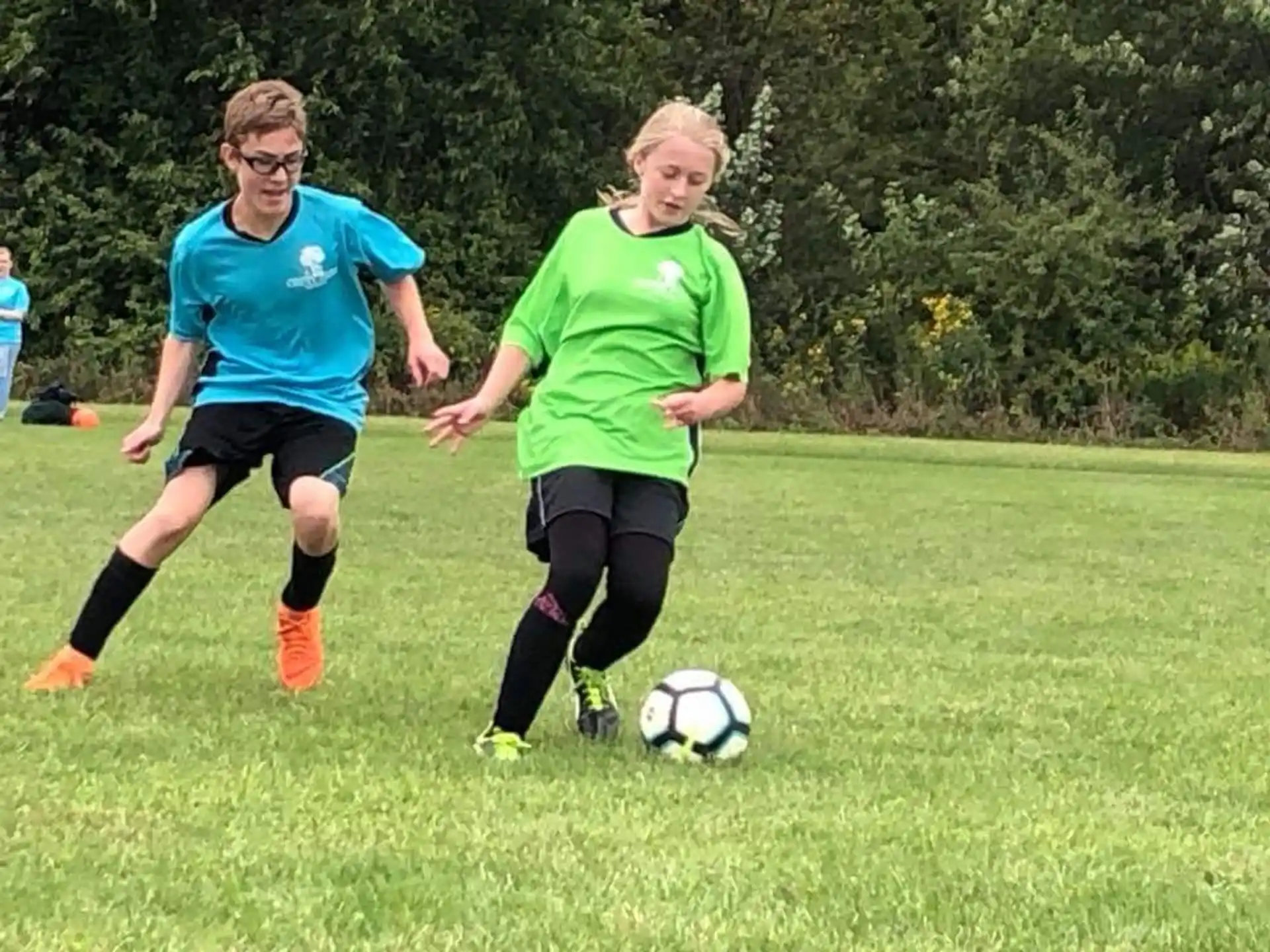 girls playing football on a field